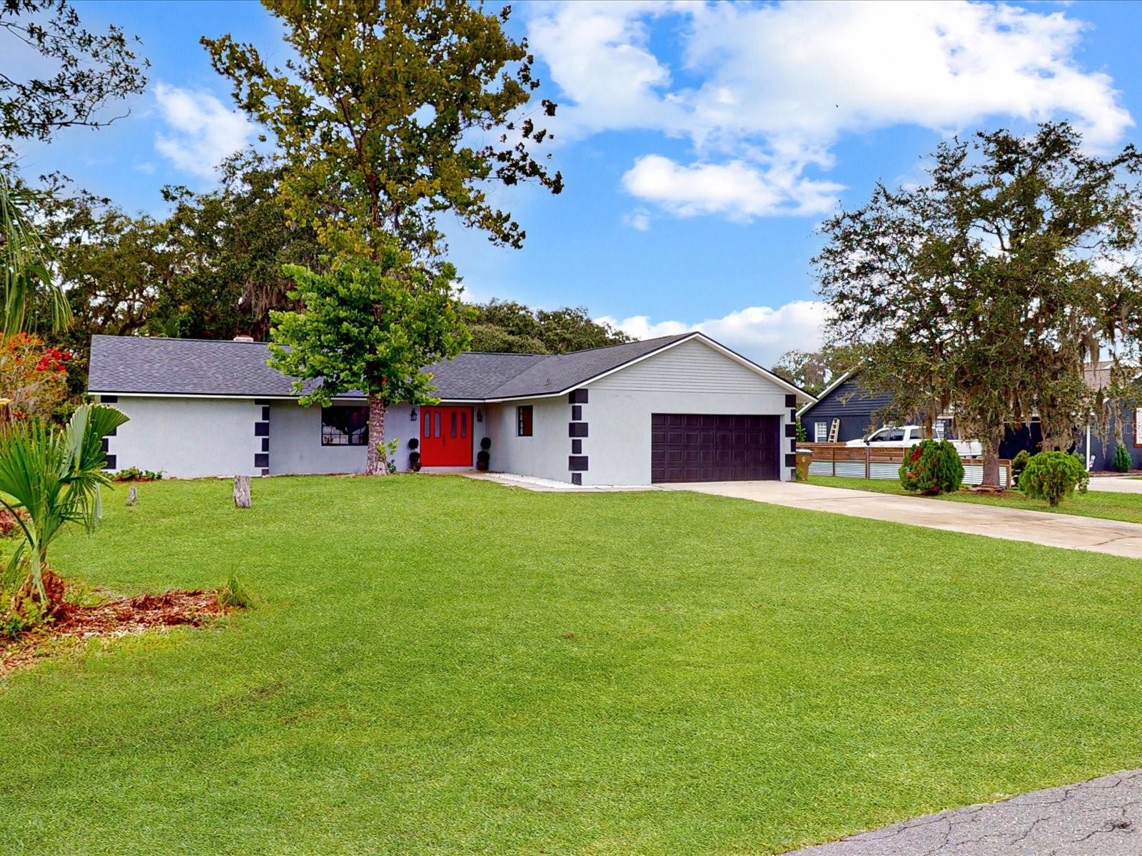 Come enjoy the beauty and peace of this spectacular remodeled home! This beautiful home located in Kissimmee has lots to provide from great restaurants, shopping centers, to being close to all of Florida’s major roads and attractions; everything one would want is close to you! Going to the house itself, be amazed at all the land available. Along with this marvelous home, you also get almost one whole acre of land! Stepping into the home, as you open those eye-catching red doors you will be filled with serenity as you see the gorgeous open floor plan. The home is spacious, and the natural light will illuminate the house to leave you stunned. Everything in this home is either brand new or recently remodeled, from the bathrooms, the kitchen, the bedrooms, to the brand-new roof and A.C., a good example of this is the kitchen. With brand new cabinets, stainless steel appliances, and quartz countertops makes the kitchen shine and is a great example of how fantastic this home truly is. Another great thing about the kitchen is the window that allows you to see into the family room and outside of the home to see the jaw-dropping view of the land and nature outside the home. The family room is huge, there is lots of room to spend time with friends and family. Stepping outside of the home, come to the back of the house to see the large amount of land that comes with the home! Enjoy the peacefulness of nature right outside your home! This home is truly one of a kind. In addition, the entire floor is laminated while the bathrooms have ceramic tiles. With three bedrooms, two bathrooms, and no HOA what are you waiting for? Come see this dream home today!