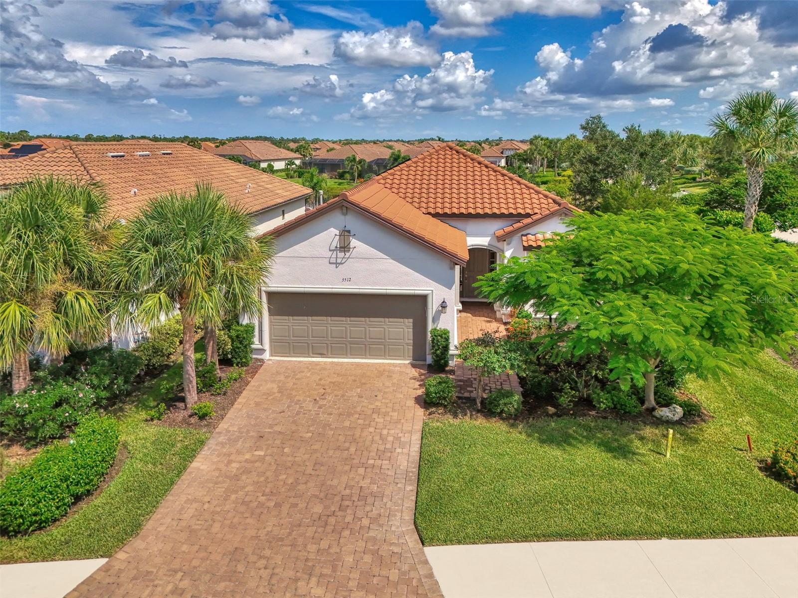 Welcome to Esplanade on Palmer Ranch, one of Sarasota’s premier gated communities offering a true resort lifestyle. This well-appointed Lazio Model lakefront home combines elegance, comfort, and luxury finishes throughout is being sold Turnkey furnished. Step inside this spacious 3-bedroom, 3-bathroom residence with tandem garage and you’ll immediately notice the attention to detail. Hurricane-impact windows & Storm Smart Shade providing whole house protection and peace of mind, while upgraded lighting, tray ceilings, and crown molding add sophistication. Beautiful laminate flooring flows seamlessly through the home, complemented by matching cabinetry and high-end quartz finishes. The gourmet kitchen is a chef’s dream, featuring a large island with seating, GE stainless steel appliances, gas cooking with a pot filler, soft-close drawers, deep storage, and a custom pantry. The open layout makes this home perfect for entertaining family and friends. The primary suite offers a tranquil retreat with a bay-window sitting area overlooking the serene lake and lanai. A custom-designed walk-in closet adds both style and functionality. The expansive lanai is the ultimate outdoor living space, designed for year-round enjoyment. Highlights include travertine flooring, wide-screen enclosure, a full outdoor kitchen with grill, sink, refrigerator, and vent hood, plus a fire pit. Enjoy the oversized heated cocktail spa—nearly the size of a small pool—or relax in the covered seating area, perfect for watching sports or sipping your favorite beverage. Additional upgrades include epoxy garage flooring, solar panels that keep the average electric bill around $38 per month. The tandem garage offers extra space for a golf cart. Living in Esplanade on Palmer Ranch is like being on vacation every day. This Taylor Morrison signature community provides a full calendar of activities led by a Lifestyle Director, along with resort-style amenities that include a pool and spa, an elegant amenity center with wellness services and catering kitchen, a fitness center and activity rooms, tennis, pickleball, and bocce courts, dog parks, fire pits, walking trails, and private access to the Legacy Bike Trail. Residents also enjoy the convenience of the on-site Bahama Bar with full-service restaurant and bar. With lawn maintenance included, this is the perfect lock-and-leave home for seasonal or year-round living. Conveniently located near world-famous Siesta Key Beach, shopping, dining, hospitals, and downtown Sarasota, this vibrant and friendly community is one of the most desirable addresses in Palmer Ranch. Don’t miss your chance to live in a true resort-style community where the amenity center is across the street. Schedule your private showing today!