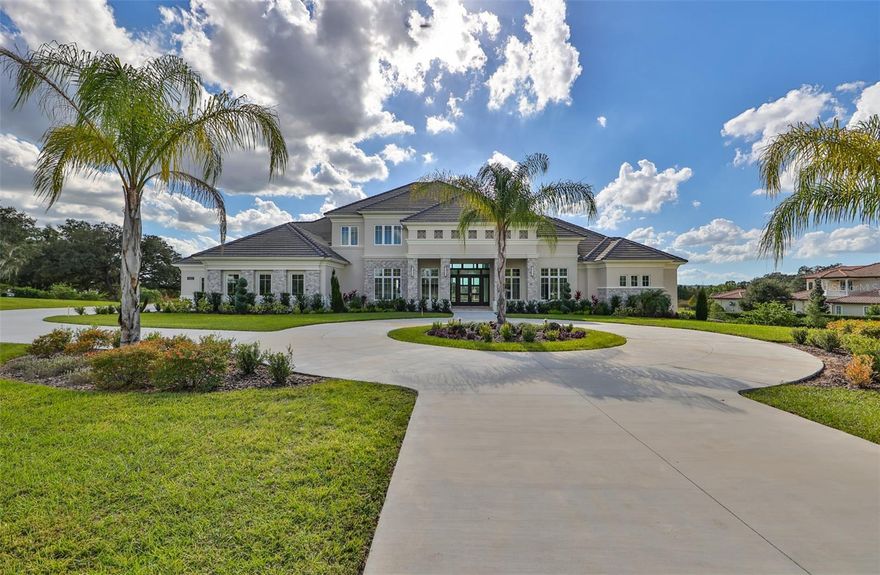 Great opportunity to own a Stunning NEW luxurious, waterfront property in one of Tampa's most premier communities, Stonelake Ranch! This beautifully designed, contemporary home is on 3+ acres of land, has six bedrooms, six bathrooms, six car garage, several walk-in closets, built in safe, two living rooms, dining room, den/office, indoor laundry room, walk in pantry, huge loft area, gas burning fireplace, walk out basement, media room, an outdoor kitchen near the pool/spa, boat ramp and boat/jet ski lift. As you enter through the front doors of your contemporary style home, you immediately have an amazing water view of Lake Thonotosassa, your private pool and spa. The family room/dining room combination has a wood burning fireplace, beautiful chandeliers and access to a breakfast bar that boasts a sink and wine refrigerator. The gourmet kitchen features stainless steel appliances, an oversized island, two wall ovens and a walk in pantry. While in the kitchen, you can still enjoy the water views of the lake, pool and spa. Beyond the kitchen, you can relax in the living room. The retractable glass doors in the living room, afford you the benefit of feeling like you are outdoors, while still being indoors. The covered outdoor space has an outdoor kitchen and is large enough to host family/friends and has direct access to the guests full bathroom. If you choose to host family/friends inside, don't worry, this home has the perfect space for this in the walk out basement. The basement has a theater room, game area, space for a gym, full bedroom, bathroom, sink and wine refrigerator. Your guests can access the basement from either the inside of the home or through the sliding glass doors under the covered lanai. The oversized primary suite has a sitting area, two customized walk in closets, access to the covered lanai and an en-suite bathroom. The enormous primary bathroom is a perfect place to relax. It has separate sinks with vanity space, stand alone garden tub and a walk around shower. The primary shower features several shower heads, built-in sitting bench and a rain shower.
As you walk upstairs, you encounter a huge loft area that can be used for another living room, play area, or workspace. There are also three bedrooms upstairs. One room has an en-suite bathroom and the other two rooms have Jack and Jill bathroom. 
The air-conditioned six-car garage is on the side of the home. The garage has stairs that lead to another space that could be used for storage, an extra closet, room or studio.
The community has 24-hour guarded gate, fitness center, exclusive events for residents, and access to the clubhouse.
The only thing missing from the community is you. Make an offer today. Bedroom Closet Type: Walk-in Closet (Primary Bedroom).