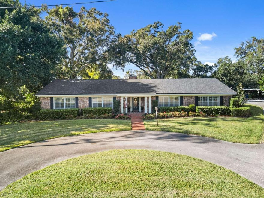 Welcome to this timeless brick beauty nestled in the serene Lake Link neighborhood of Winter Haven, Florida—a hidden gem in Polk County offering convenience and tranquility. This spacious single-family home, built in 1967, boasts 3 bedrooms, 2.5 bathrooms, and an impressive 3,232 square feet of living space on a generous 0.53-acre fenced lot with mature oak trees and a lush, tropical tiered backyard perfect for outdoor entertaining or peaceful relaxation. Step inside to discover a cozy brick fireplace in the living room, a formal dining room, and a dedicated library ideal for quiet reading or a home office. The heart of the home is the massive Florida room, featuring stunning brick walls and flooring, enveloped in picturesque French doors that flood the space with natural light and provide seamless views of the private backyard. The updated kitchen features corian counters, a central island with additional sink and appliances including a dishwasher, microwave, oven, range, refrigerator, motion activated faucet and disposal. Additional interior highlights include plantation shutters on all windows, crown molding throughout and thoughtful details like an inside utility room and breezeway. Outside, the traditional brick exterior exudes classic charm, complemented by a detached oversized garage, an additional 2-car carport, and circular driveway for ample parking and easy access. The neighborhood stands out for its peaceful family-friendly atmosphere with no HOA fees or restrictions, conveniently near shopping, restaurants, downtown Winter Haven and Polk State College. Located in vibrant Winter Haven, known for its famous Chain of Lakes and proximity to attractions like Legoland Florida, this home combines mid-century appeal with modern updates, making it a secure investment in a prime Central Florida location. Don’t miss the opportunity to own this immaculate retreat!
Additional items: Washer & Dryer included New well pump, valves, irrigation heads New electrical box New roof and new wood where needed Freshly painted exterior Double paned windows Two car garage with multiple closets for storage