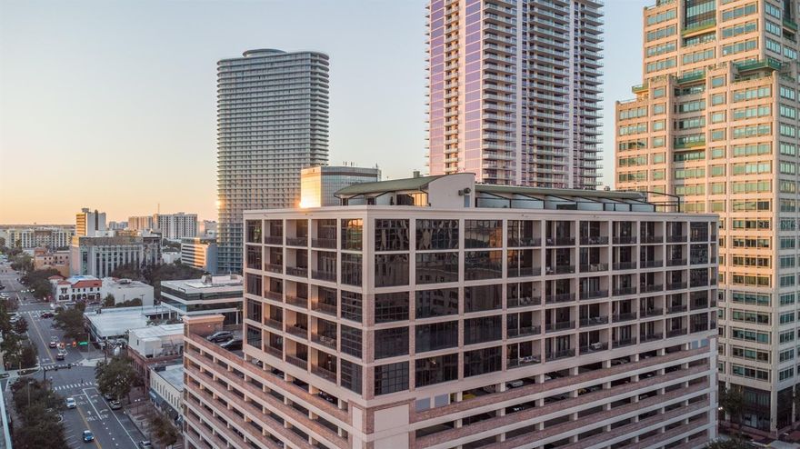 Wake up to sweeping views of Tampa Bay, the St. Pete Pier and Albert Whitted Airport, all from the heart of downtown. This fully renovated eighth-floor residence offers a front-row seat to everything that makes St. Petersburg one of Florida’s vibrant coastal cities. Inside, floor-to-ceiling windows flood the space with natural light and offer stunning city and water views from nearly every angle. Tall, 11-foot ceilings showcase a sleek, industrial design that showcases McNulty Lofts as one of the unique buildings in downtown St. Pete. This open layout is anchored by a chef’s kitchen that has been thoughtfully designed with high-end finishes, beautiful cabinetry, stone countertops and modern appliances. The kitchen island provides ample bar seating and there is even space for additional dining table to add to your entertaining needs. From the spacious living room, step out onto your private balcony to take in the sunrise over the bay or watch the nightlife sparkle below. This unit features a guest room with en-suite bath and a laundry room with plenty of storage. Off the living room, the primary suite feels like its private retreat, complete with a unique space that can be used as an office or a reading nook. The en-suite bath will be your private spa experience with a dual sink vanity, glass-encased walk-in shower and a gorgeous free-standing tub combination design. Every detail throughout the home has been carefully curated, offering a seamless blend of luxury, comfort and modern design. Downstairs, the lobby and fitness center have been recently renovated to elevate your experience. You’ll enjoy two secured, under-building parking spots, a rare thing in downtown! Just a short distance from famed Beach Drive, world-class dining, top-rated museums, waterfront parks and St. Pete Pier, you’ll have everything you need right at your fingertips. Hear the sights and sounds of downtown St. Pete and the Tampa Bay Rowdies from the comfort of your own balcony. Head down and catch the SunRunner to go take in a baseball game or other fun activities along Central Avenue, and even all the way out to the beach. This is downtown living at its finest, where walkability, views and refined interiors come together effortlessly. Call for your private showing today.