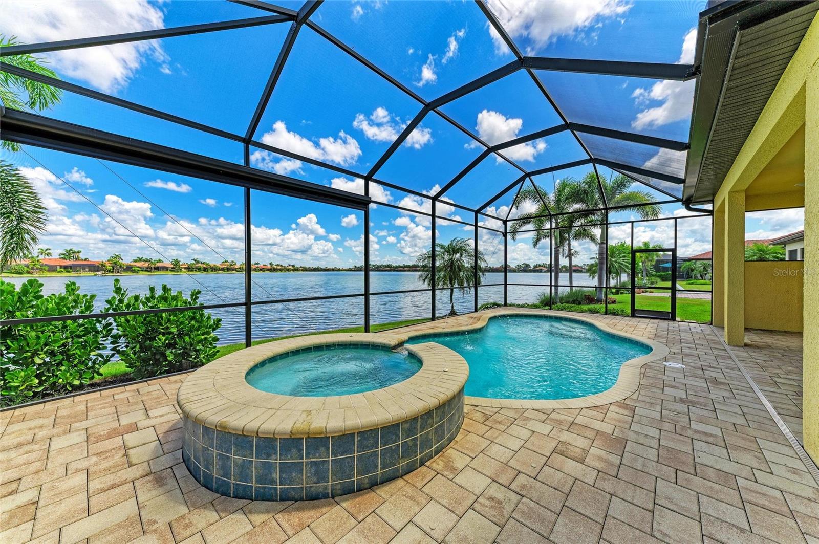 This is a remarkable opportunity to acquire a spacious and impeccably maintained 3BR waterfront pool home, complete with an additional den and a loft, and offering 2.5 bathrooms. Nestled on a waterfront homesite in the resort like Toscana Isles community, renowned for its expansive recreational lakes, this property is ideally situated just a short distance from the community center, so you can easily participate in community activities. This airy and open floor plan features soaring ceilings over 11 feet high, a generously sized kitchen, a cozy dinette, and a grand great room. The first-floor owner's suite, boasts two walk-in closets, a soaking tub, a walk-in shower, dual vanities, and a makeup counter. The expansive den at the front of the home, fitted with French doors, can be utilized as a formal office or additional living area. This home showcases impressive designer upgrades, including natural tile and engineered hardwood floors on the main level, high-end stainless steel appliances, 42-inch cabinets with both under-cabinet and over-cabinet lighting, 8-foot doors throughout, grand baseboards, and premium light fixtures and fans. The large secondary bedrooms upstairs offer privacy and comfort for your guests and family, and include hurricane impact-windows. The airy loft/bonus room is perfectly suited for a game room or an additional office, catering to those who require multiple work or play spaces. The garage features an epoxy-finished floor. Outside, the sizable lanai and pool/spa area provide stunning long lake views over Lake Awesome, enhanced by privacy screens and lush, mature landscaping, creating the ambiance of a private tropical estate while remaining conveniently close to amenities. Additionally, the home features a fenced side yard, ideal for your furry companions. The community includes a resort-style clubhouse, an infinity-edge beach-entry pool, a gym, tennis and pickleball courts, a playground, and a dog park, all just a short walk away. Residents can kayak, canoe, or fish in 200 acres of interconnected lakes and take part in a variety of community activities. Toscana Isles is a gated community located only 6 miles from the stunning Suncoast Beaches, offering an excellent school district and easy access to shopping, healthcare facilities, including the new Sarasota Memorial Hospital Venice Campus, and I-75. Don’t miss your chancecall today to schedule a private showing!
