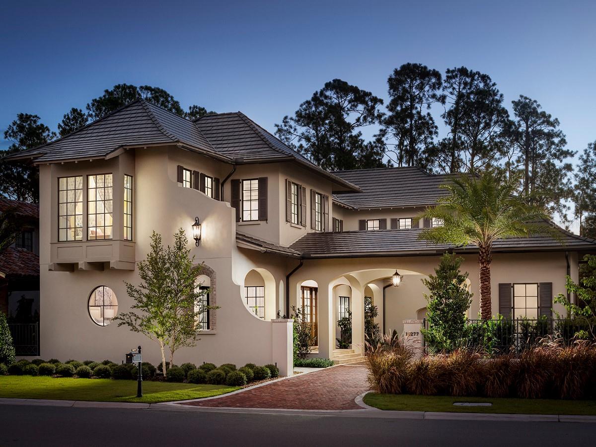 This gorgeous Island Colonial welcomes you to a life of luxury and relaxation. The quaint courtyard and porte-cochère convey a resort-like experience upon arrival. From the grand entry, discover a sun-drenched great room accented with soaring ceilings and an artfully designed wine room. The outdoor living area offers the perfect venue for entertaining, while the home’s two-story formal dining room is a conversation piece on its own. Other features include an elegant primary suite, a ground-floor guest suite and a chef’s kitchen featuring a granite center island. Golden Oak at Walt Disney World® Resort is a residential resort community where families can live in the embrace of luxury, privacy and the magic of Disney. This gated community features distinctive neighborhoods of magnificent homes, expansive natural preserves and inviting amenities—including access to Golden Oak’s private clubhouse, Summerhouse, with superb food offerings served in a casually elegant dining room, courtyards, pool area, fitness facilities, and family room. In addition, residents have access to Club Life, Your Special Connection to the Magic, including access to the Golden Oak Member Services team, park transportation, signature club events, theme park experiences, and much, much, more. Also at Golden Oak is Four Seasons Resort Orlando at Walt Disney World® Resort, which hosts the 18-hole Tranquilo golf course, full-service spa, meeting facilities, and superlative restaurants.