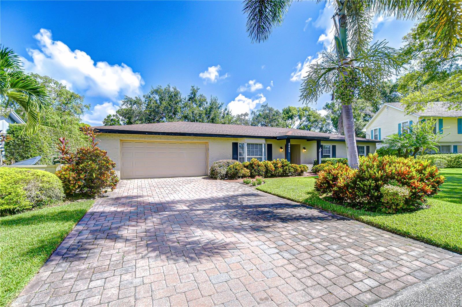 Timeless Carrollwood Beauty – Rarely Available Single-Owner Gem. Perfectly situated in the heart of Carrollwood, this 4-bedroom, 2-bath residence has been lovingly cared for by the same family since 1979, a true rarity in today’s market. Offering 2,319 sq. ft. of inviting living space, the home blends modern updates with classic character, from the paver driveway and manicured landscaping to the brick façade accented by shutters on the front windows and coach lights. A brick walkway leads to the portico entrance with a wood front door featuring an oval glass insert, while a RING doorbell adds modern convenience—an inviting introduction to the beautifully maintained interiors that await. Step inside to a welcoming foyer with a convenient hall closet, where pride of ownership is immediately apparent. The freshly painted interior showcases warm wood floors flowing through the living and dining rooms and all four bedrooms, while ceramic tile enhances the kitchen, family room, and enclosed Florida room. The formal living room features a charming bay window that fills the space with natural light, accented by elegant crown molding. The adjoining dining room also offers crown molding, providing a warm and inviting setting for gatherings and celebrations. At the heart of the home, the kitchen boasts oak cabinetry offering abundant storage, gleaming granite countertops, and a decorative tile backsplash with custom Decora tile accent. A stainless double sink with an open pass-through overlooks the Florida room, while a second prep area with matching cabinets, counters, and backsplash adds convenience for cooking and entertaining. From the kitchen, flow into the enclosed Florida room, enhanced with crown molding, three ceiling fans, a storage closet, and direct access to the backyard. A granite-topped counter creates a seamless transition to the family room, where a built-in media center completes this versatile living space. Down the hallway, accented with a classic chair rail, you’ll find the updated hall bath featuring a granite-topped vanity with double drawers and an undermount sink, a large tiled shower enclosed with seamless glass and highlighted by a Listello contrast pattern, and a convenient built-in linen closet. The spacious primary suite offers a wall-length double closet and a private ensuite with separate vanities, a seamless glass-enclosed tiled shower, a built-in linen closet, and custom shelving. Three additional bedrooms are generously sized, providing comfort and versatility for family or guests. Outdoors, discover your own tropical oasis, designed for both relaxation and entertaining. A paved patio area is thoughtfully separated by mulched and stone sections, surrounded by stunning landscaping. Adding to the appeal is a built-in, air-conditioned shed, offering the perfect solution for year-round storage or workshop space.
With its timeless charm, thoughtful updates, and meticulously maintained spaces, this Carrollwood residence is truly move-in ready. Beyond the property itself, you’ll enjoy the unbeatable convenience of Carrollwood living—close to top-rated schools, neighborhood parks, shopping, dining, and just a short drive to downtown Tampa, Tampa International Airport, and the Gulf beaches. Opportunities like this don’t come often—schedule your private showing today.