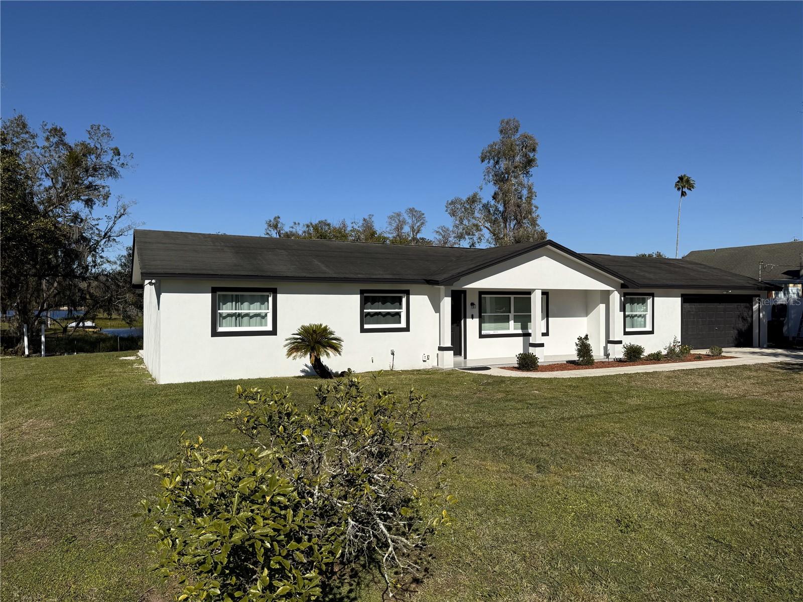 Welcome to your dream home located in Lutz, Florida and offers 3 bedrooms, 2 baths, 2-car garage. This waterfront home has a canal in the back that leads to lake "Keene". This home has been totally renovated. The flooring is 2.7 x 2.7 Glazed Porcelain tile in all rooms, renovated bathrooms with quartz countertops and double vanities. The primary bedroom is large enough for a sitting area and a walking closet. The kitchen is all new with new cabinets, double bowl sink, quartz countertops with an island and a built-in pantry. All existing kitchen appliances included. New water heater, new water filtration system, new central heat and air unit. No HOA, NO CDD and sits in flood zone X where flood insurance is mostly not required. Home is being sold in "AS IS "condition.