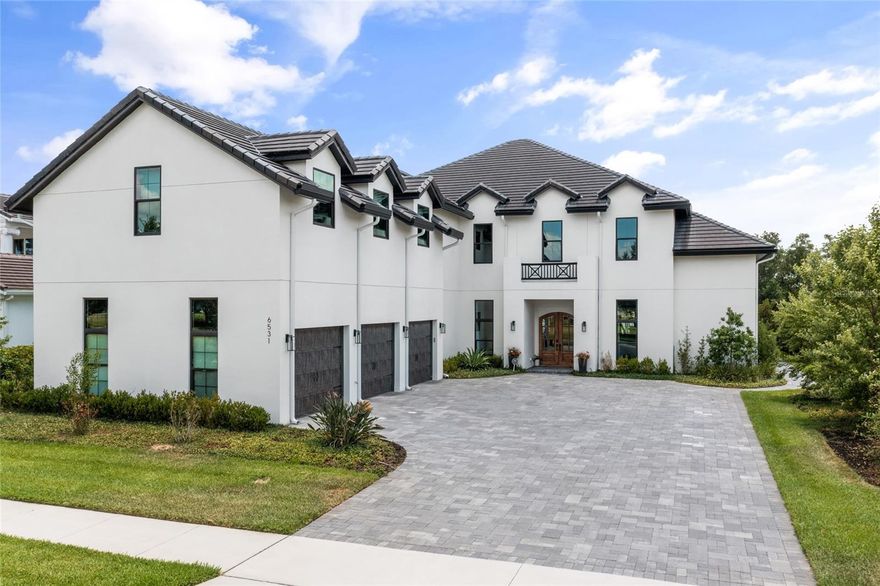 Independence ** PRICED BELOW RECENT APPRAISAL APRIL 2024 $2,900,000 *** Spectacular 2021 custom built lakefront home with stunning views of skiable Lake Hancock & Disney firework views ** Dock has electric & covered boat lift for boats up to 22' & 8000 lbs ** Sleek and modern kitchen offers a spacious kit island, quartz counters, flush ceiling mount rangehood, walk in pantry + 2 separate pantries on each side of the Thor double gas stove/oven ** The din area offers a full wall of cabinetry & lake views ** Loads of light in the living room w 26' soaring ceilings and full wall to ceiling slate tile accent wall featuring a gas fireplace ** The PGT quadruple sliding glass doors open fully to the outdr liv area w/serene lake Hancock views ** Striking First floor master bdrm & en-suite lavish master bath offers custom light wood vanities w/white quartz counters, a free standing soaking tub & a +/-12x10 walk-in closet w island ** To the right side of the foyer, is a possible inlaw suite or 2nd master suite offering a full bath and spacious walk in closet ** All bedrooms are en-suite ** Attractive natural wood plank tile through-out the main rooms & light wood staircase ** Upstairs you will find a fantastic game room +/-21x37' w full bar & built-ins plus several niche areas *Other home features incl LED recessed lighting through-out the home, PGT windows w/black trim inside and out, PGT sliding glass doors in the dining and living rms, foam insul & in block, 3 tankless hot water tanks, built in closet shelving, special space with 2 built in dog kennels off the garage, 2 dens one on the first flr & one on the 2nd flr** 2 laundry rooms - 1st flr offers built in cabinetry **Media room with space with 2 tiered seating ** Great loft space overlooking the living area ** The outstanding heated pool features a raised spa, sun shelf and a 2nd raised waterfall feature **Exceptional outdoor space perfect for entertaining offering an expansive patio with perimeter LED lighting, a gathering area with wood burning fireplace & outdoor kitchen with counter bar seating **County records have incorrect square footage. Recent Appraisal shows home has 5673sf. All room measurements, dock, boat house are approximate measurements and should be verified by buyer ** Jet ski Dock does not convey **