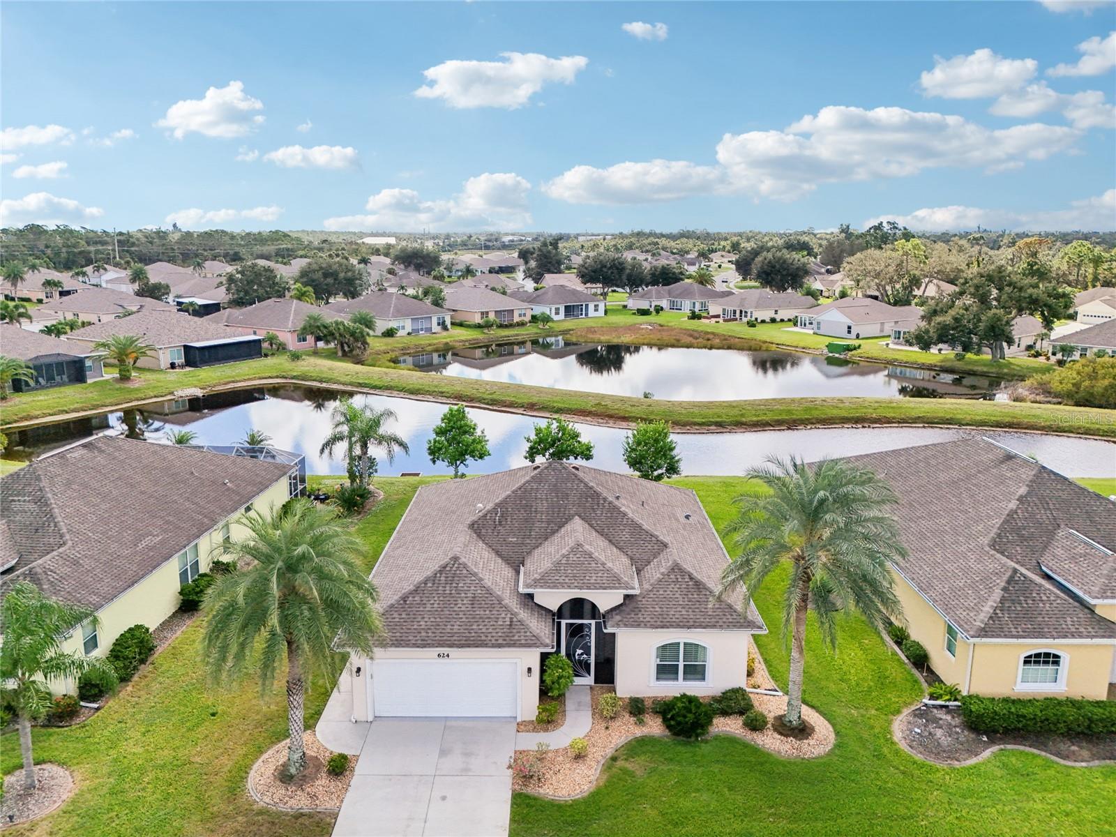 Welcome to relaxed pond-front Florida living at its finest in Park Forest. This fully furnished Garnet model, offering 3 bedrooms, 2 bathrooms, and a 2-car garage, blends comfort, beauty, and the ease of a maintenance-free and golf cart friendly community. From the moment you arrive, the home’s tropical curb appeal and screened front entry with a leaded glass door create a warm welcome. Step inside to find a bright and spacious great room with crown molding, volume ceilings, plantation shutters, oversized baseboards, and new wood-look tile floors that flow throughout the main living areas. The open layout makes it easy to enjoy everyday life or entertain friends, with triple pocket sliders leading to the impact-glass-enclosed Florida room where you can relax and watch the wildlife that frequents the pond. The large kitchen features abundant 48-inch wood cabinets, granite countertops, a raised breakfast bar, and both under-cabinet and pendant lighting. The adjoining dining area offers a large window with lovely lake views and sliding doors for easy access to the Florida room, making entertaining effortless. The primary suite feels like a peaceful retreat with a tray ceiling accented by crown molding, a walk-in closet, and a private bath featuring dual sinks, granite counters, and a glass-door, fully tiled walk-in shower. Both guest bedrooms are spacious with reach-in closets, and the guest bath includes a large, fully tiled walk-in shower. The interior laundry room is thoughtfully designed with built-in cabinets and a granite-topped folding area for added convenience and storage. Impact windows and an accordion shutter for the front door provide peace of mind, while the maintenance-free lifestyle lets you enjoy community amenities such as the pool, tennis courts, and recreation center. There’s even on-site storage available for your boat or RV. Park Forest offers a full social calendar and a friendly neighborhood atmosphere, all less than 10 miles from Gulf beaches, world-class fishing, boat ramps, hiking trails, parks, golf courses, shopping, and medical facilities. This is a wonderful opportunity at 624 Barnacle Court to live your dream Florida lifestyle. Call today to schedule your private showing.
