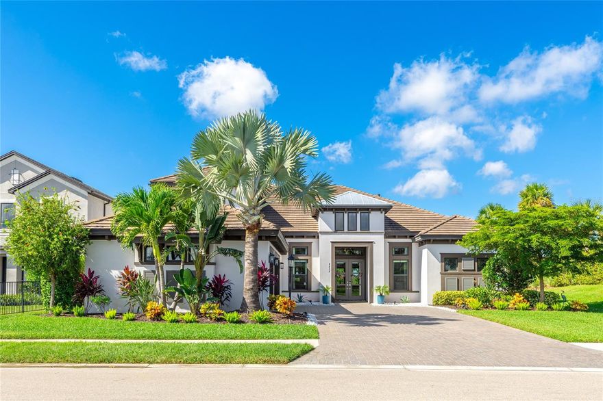 Perfection in Skye Ranch. This former Beacon model offers refined design and effortless indoor and outdoor living on a private preserve lot. Completed in 2020, the home features 4,541 square feet of thoughtfully curated space with soaring ceilings, a great room with custom built-ins and a fireplace, and an entertainer’s kitchen with an oversized island, built-in ovens, a walk-in pantry, and lit cabinetry. The main level includes a study, formal dining area, two en suite guest rooms, and an owner’s retreat with patio access, dual custom closets, and a spa bath with an oversized dual entry shower. Upstairs, a spacious game room with a wet bar and full bath adds flexibility for guests or recreation. Pocket sliders open to a resort-style lanai with pool, spa, and summer kitchen surrounded by peaceful preserve views. Features include impact windows, motorized shades, whole-home audio, three-zone HVAC, and a three-car garage. Located within the gated Cassia neighborhood, just minutes to top schools, Waterside, and Siesta Key.