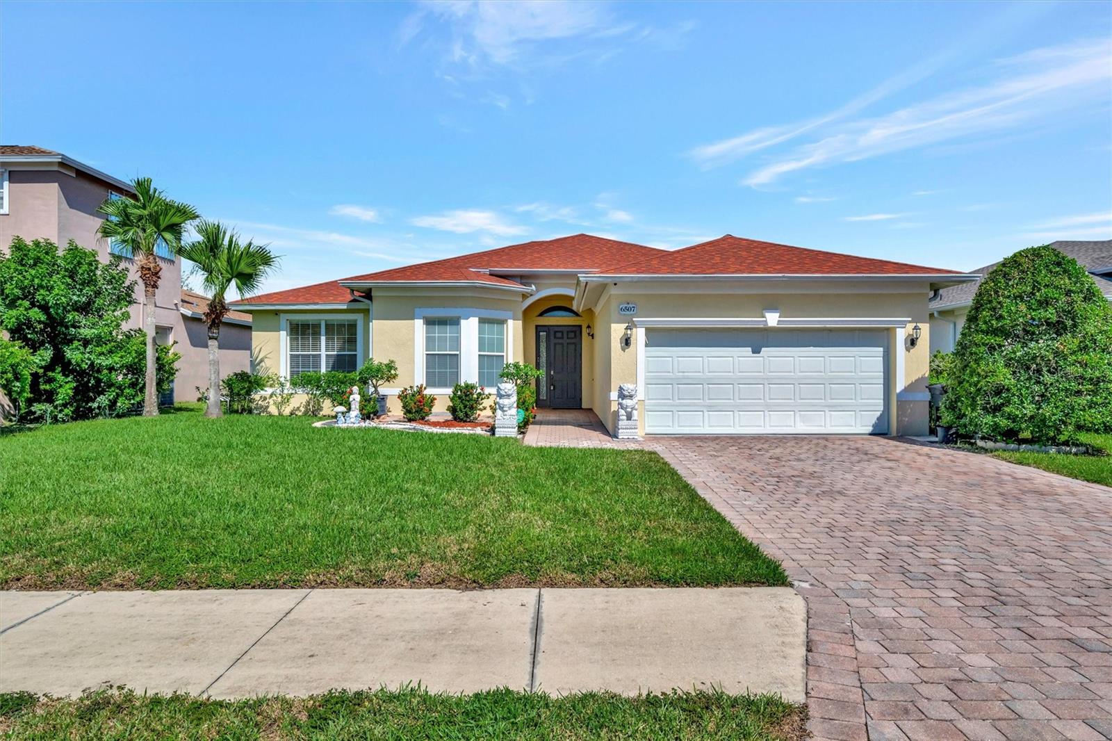 This spacious 3 bedroom, 2 bathroom home offers a versatile layout with additional room that can serve as a home office, play nook, or formal dining room. The kitchen features a breakfast bar and eat-in space, opening to a large oversized family room perfect for gatherings. The primary suite is tucked privately at the back of the home, complete with a garden tub, dual vanities, and a separate shower. Two guest bedrooms share a bathroom designed with a private commode and shower room for added convenience. Additional highlights include an indoor laundry room with washer/dryer provided, a large garage with fresh epoxy floors, and the entire home painted in a light coastal hue, all set for your upcoming move! The backyard provides a tranquil setting ideal for potted plants or a zen garden, while the community offers a refreshing pool for residents to enjoy.