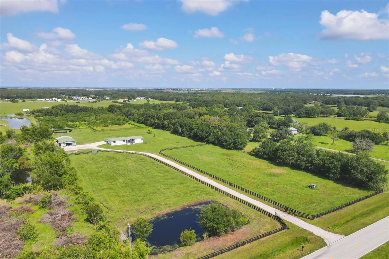 LOCATION, LOCATION, LOCATION!
Nestled in the exclusive Waterbury Tracts near Panther Ridge, this lush 10-acre, fully fenced and cross-fenced property is a rare opportunity to own prime equestrian land in one of the most sought-after areas of East Manatee County. Surrounded by luxury estate homes, this exceptional parcel offers a perfect blend of rural charm and modern convenience, just 13 miles from Lakewood Ranch, 14 miles from TerraNova Equestrian Center, and a scenic 2-hour drive to the World Equestrian Center in Ocala. Build your dream estate on this picturesque property featuring a private pond, mature shade trees, a new gravel driveway and custom gated entry welcome you to a property that is ready for both immediate use and future development. Bring your horses to the FULLY OPERATIONAL 8-STALL BARN with a durable metal roof, tack room, wash area, barn office, and RIDING RING. Train, ride, and thrive on your own land, surrounded by the best equestrian amenities Southwest Florida has to offer.
A 4-bedroom, 2-bath manufactured home with a 3-car carport currently sits on the property. While the home needs some love, it provides multiple options: buyers can keep and renovate it, utilize it as a residence for a property manager or caregiver, or have the SELLER MOVE OR REMOVE the home at the buyer’s direction, offering a rare flexibility not often found. This is a prime opportunity to build your custom dream home without the added costs of demolition. THERE IS NO OTHER PROPERTY LIKE IT ON THE MARKET!
This is a unique offering— with this combination of acreage, location, and equestrian amenities. You’ll enjoy quick access to world-class equestrian venues, Gulf Coast beaches, fine dining, shopping, entertainment, and international airports. Whether you envision a luxurious country estate or a working equestrian property, this land offers endless potential in one of the most sought-after areas of Southwest Florida. You will want to see this property, call for your private tour in person or via Facetime!