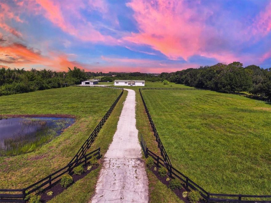 Location, location, location! In the exclusive Waterbury tracts near Panther Ridge, this lush 10-acre fully fenced and cross-fenced property is a rare opportunity to own prime equestrian land in one of the sought-after areas of east Manatee County. Surrounded by luxury estate homes, this exceptional parcel offers a blend of rural charm and modern convenience, just 13 miles from Lakewood Ranch, 14 miles from Terranova Equestrian Center, and a scenic two-hour drive to the world equestrian center in Ocala. Build your dream estate on this picturesque property featuring a private pond, mature shade trees, a new gravel driveway and custom gated entry welcome you to a property that is ready for immediate use and future development. Bring your horses to the fully operational eight-stall barn with a durable metal roof, tack room, wash area, barn office and riding ring. Train, ride, and thrive on your own land, surrounded by the best equestrian amenities Southwest Florida has to offer. A four-bedroom, two-bath manufactured home with a three-car carport sits on the property. While the home needs some love, it provides multiple options such as buyers can keep and renovate it, utilize it as a residence for a property manager or caregiver, or have the seller move or remove, the home per the buyer’s direction, offering a rare flexibility not often found. This is a prime opportunity to build your custom dream home without added costs of demolition. There is no other property like it on the market! This is a unique offering—with this combination of acreage, location and equestrian amenities. You’ll enjoy quick access to world-class equestrian venues, Gulf Coast beaches, fine dining, shopping, entertainment and international airports. Whether you envision a luxurious country estate or a working equestrian property, this land offers endless potential in one of the sought-after areas of Southwest Florida. You will want to see this property, call for your private tour in person or via FaceTime.