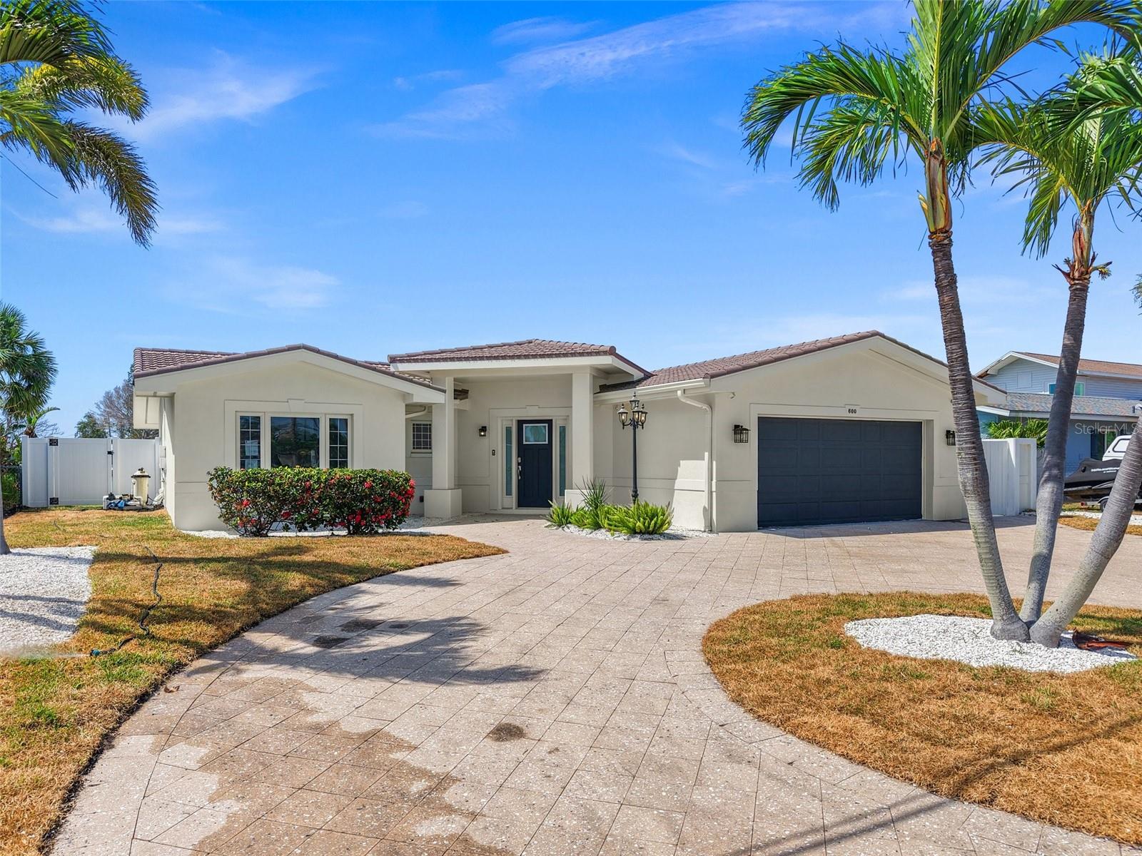 Wake up to breathtaking wide-open water views and launch your boat straight into the Intracoastal—this luxury-remodeled coastal home is the ultimate waterfront lifestyle.
Perfectly positioned just minutes from the sandy shores of Treasure Island's Beach, top-rated restaurants & bars with live music, boutique shopping, & close to the weekend farmers market. This 3-bedroom, 2-bath concrete block home has been completely transformed with high-end finishes and a fresh, modern design.
Inside, the open-concept layout flows effortlessly from the designer kitchen to the dining and living areas, all framed by expansive water views. Sleek new large Tile flooring, upscale lighting, and refined fixtures add sophistication and ease throughout.
Step outside to your resort-style pool built in 2019 overlooking the water, while the new seawall in 2018 and galvanized metal roof put on in 2009 ensure long-term peace of mind. Whether you're sailing, fishing from your dock, kayaking, or cruising to the Gulf with no fixed bridges, this home is made for those who live for salt air and sunsets.
While the property did experience flooding during the hurricane; it was issued a non-substance letter. It has been fully and tastefully renovated, making it move-in ready for a discerning buyer seeking true waterfront living with the best of Treasure Island at your doorstep and downtown St. Petersburg just a short drive away. Check out this video - https://youtu.be/np_r70jvqZc