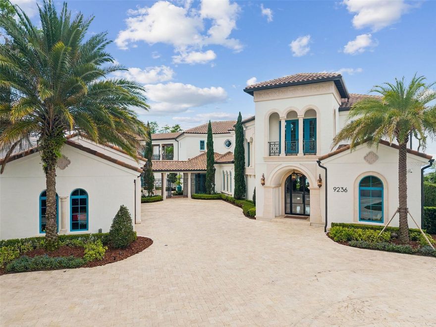 Located within the gated community of Bay Point in Bay Hill, this lakefront estate offers a rare combination of luxury, comfort, and waterfront living on Lake Tibet, part of the renowned Butler Chain of Lakes. Designed to capture beautiful lake views throughout, the home blends elegant architectural details with spaces that feel warm, open, and inviting.
From the moment you arrive, the stone driveway, impressive architecture, and 4 car garage create a strong first impression. Inside, the custom glass entry opens to soaring ceilings, designer fixtures, a grand staircase with glass railing, and dramatic floor-to-ceiling windows that immediately draw your eye to the lake. The open floor plan is ideal for both everyday living and entertaining, with seamless flow between the main living areas and outdoor spaces.
With nearly 10,000 square feet, the home offers exceptional flexibility for family and guests. The layout includes two spacious primary suites, one on each level, two additional en-suite bedrooms in the main residence, and a private guest apartment with its own suite. Additional features include maid’s quarters with a walk-in closet and full bath, private gym, sauna, elevator, and a stunning wine cellar that wraps around the staircase.
The gourmet kitchen serves as the heart of the home, featuring top of the line appliances, an oversized quartz island, custom cabinetry, and a hidden pantry door leading to a large walk-in pantry. Large accordion doors open the kitchen and living areas to the covered lanai, summer kitchen, and resort-style backyard.
Outside, the lakefront setting is exceptional, with an infinity edge pool and heated spa, outdoor entertaining areas, touchless curtains, covered dock, one boat slip, and two ski lifts. Lake Tibet is one of 13 lakes that make up the Butler Chain of Lakes, offering approximately 5,000 acres of water surface for boating, skiing, and Central Florida lakefront living. Bay Point residents also enjoy community amenities, including a pool and clubhouse, all with convenient access to dining, shopping, top rated schools, major highways, Orlando International Airport, and Lake Nona Medical City.