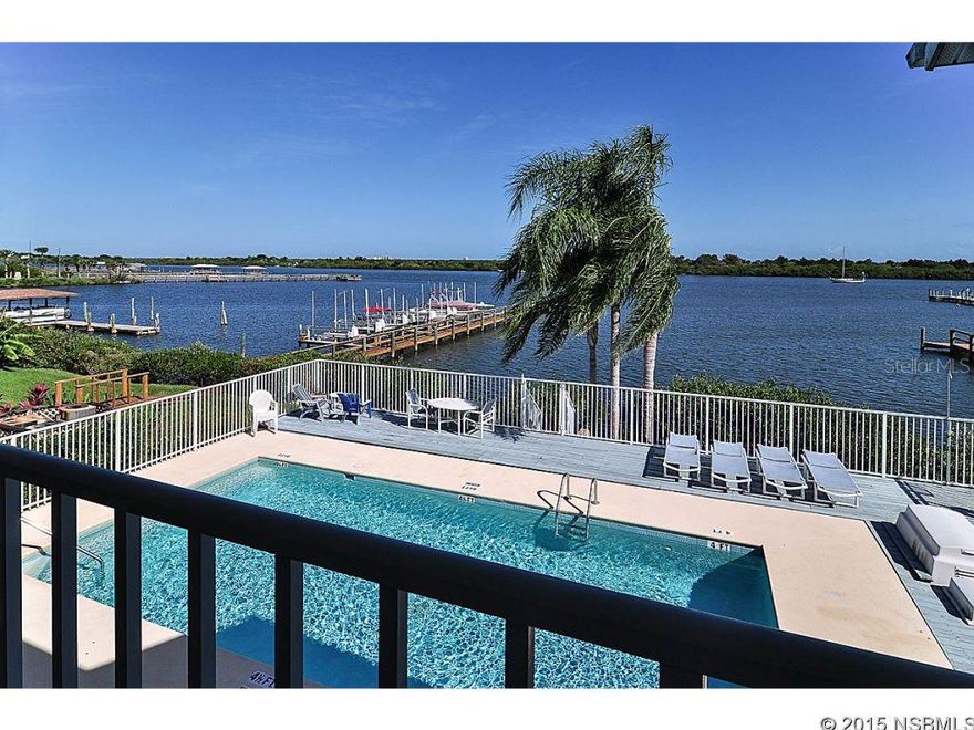 Direct Riverfront living at its finest & Exclusive use of boat slip, with boat lift included!  Two âstory townhome with pool & direct river views when you walk through the etched glass front door.  Kitchen, dining area and living room overlooking the pool area out to the Intracoastal Waterway.  Wood laminate flooring in entry way through to the kitchen.  Kitchen has lovely  updated wood cabinets with stainless steel appliances.  Beautiful under cabinet lighting with corian countertops.  Breakfast bar area.   Carpeted dining area and living room, with large mirrored wall in living room to take in more of the views.  Large, tiled half bathroom downstairs.  Up the carpeted staircase  leads you to the second level where you find two bedrooms and two full bathrooms.  Large master suite has private balcony overlooking pool and direct river views.  Master suite has private bath, with double vanities and walk-in shower.  Master also has a large closet with vaulted ceilings.  Guest bedroom has built in bookcases and a bathroom with tub and shower.  Both bedrooms are carpeted and baths are all tiled flooring.  Enjoy the large one car garage with pull down attic space.  The community offers a river front pool area and two docks to enjoy and access the river . ;Water: City