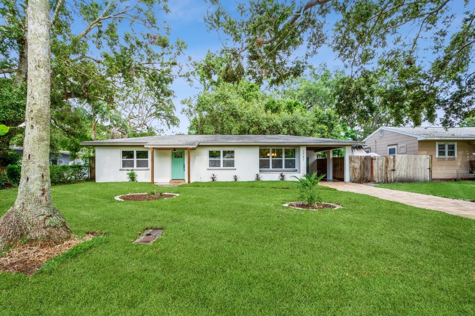 This fully remodeled 2 bedroom, 1.5 bathroom single story home is in a prime location just minutes from the many shops and restaurants of downtown Dunedin! Designer finishes and new luxury vinyl plank flooring are found throughout the home, which has a great floor plan perfect for living and entertaining. The spacious and bright living room is open to the kitchen which features new shaker cabinets, quartz counters, new stainless appliances and space for an eat-in area. Laundry and a chic powder bathroom are just off the kitchen, which also leads out to the covered car port with new tongue-and-groove ceiling. A separate dining room surrounded by windows streams in natural light. Two spacious bedrooms share the full bathroom which has a new tiled shower. The spacious fenced backyard has a seashell gravel patio and ample space for a pool. Other features include new impact-rated vinyl windows throughout, updated electrical and newer HVAC (2020) and water heater (2022), and a large storage room at the back of the car port. This home is nestled in a golf cart-friendly neighborhood of picturesque homes which the Pinellas Bike Trail runs right through. It is also a short stroll to Hammock Park, Dunedin Golf Club and Honeymoon Island. This home sat HIGH AND DRY with NO FLOODING OR STORM DAMAGE during Helene and Milton.