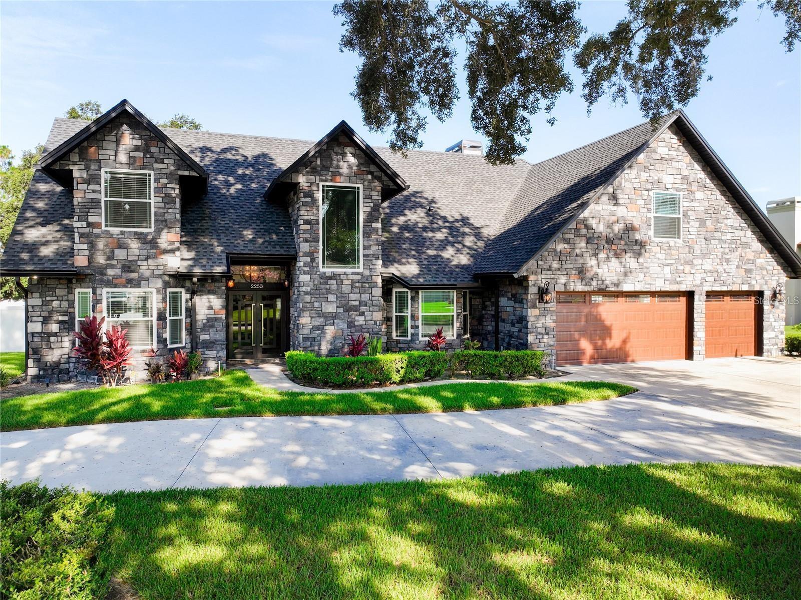 Step inside this stunning 5-bedroom, 4-bathroom pool home located in the highly desirable Bloomfield Hills community of Lakeland! Featuring over 3,300 square feet of luxurious living space, this residence offers elegance, comfort, and privacy on a spacious half-acre fenced lot. The home has been completely remodeled with modern finishes including new flooring, roof, and air conditioning (2021). The gourmet kitchen is equipped with GE Café stainless steel appliances, a built-in microwave, a wine cooler, and a large center island overlooking the open concept family and dining areas. Enjoy custom stone walls, elegant chandeliers, and high ceilings that make every room feel grand. The bathrooms are spa-inspired with rainfall showerheads and designer fixtures. Step outside to your private backyard oasis a newly resurfaced screened pool, covered patio, and cozy firepit perfect for entertaining. Additional highlights include a three-car garage, tankless water heater, mature landscaping, and a “hidden room” for extra storage or creativity. Conveniently located near I-4, shopping, and dining, this exquisite home blends sophistication and functionality. Schedule your private showing today you’ll fall in love at first sight!
