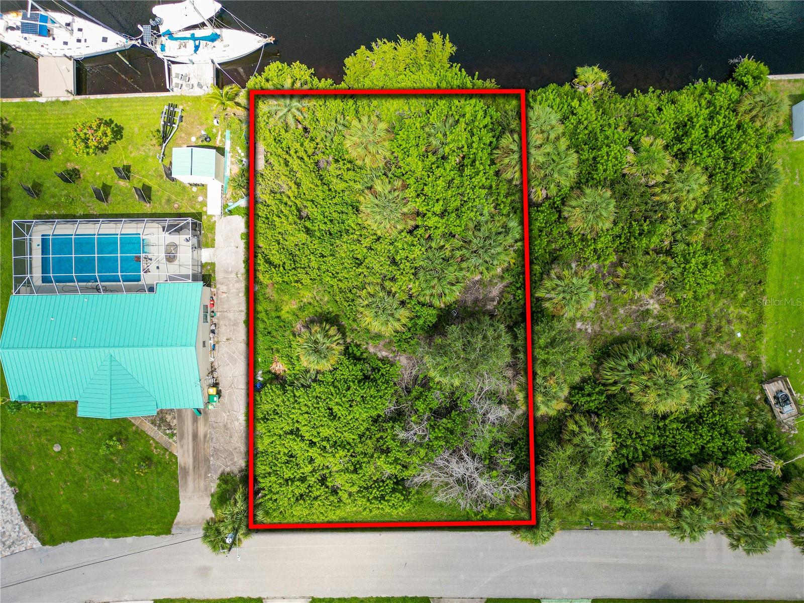 Have a sailboat or maybe looking to buy one? You can now tie up your sailboat in your backyard with this sailboat-depth waterfront lot on a relaxing saltwater canal with no fixed bridges to Charlotte Harbor. This vacant lot comes ready for for you to design your dream home, with public water and sewer available. Located in Port Charlotte, just minutes from waterfront parks, vibrant dining, shopping, and right down the water from the newly opened Sunseeker Resort, this is the Florida lifestyle you have been wanting. Whether you're a sailing enthusiast looking to build your dream home or just looking to have quick access by your boat to Charlotte Harbor, this is your land to live the coastal lifestyle you've been searching for. If you want to get your plans started soon, we have a local builder ready to turn your vision into a waterfront reality.