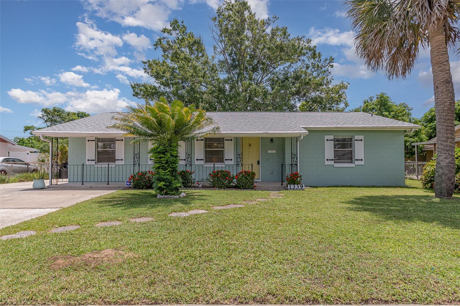 This beautifully remodeled three-bedroom, two-bath home with a versatile bonus room and private entrance is truly move-in ready and worry-free. Step inside to rich commercial-grade LVP flooring, sparkling quartz counters, elegant new cabinets, and fresh, inviting paint inside and out. The kitchen gleams with brand new stainless appliances, garbage disposal, and a convenient washer and dryer. Modern lighting and ceiling fans in every room add style and comfort. Enjoy peace of mind with a brand new 2025 roof, new water heater, and well-maintained 2016 AC. No HOA and city water/sewer simplify life. Outside, relax in the screened enclosure among mature landscaping, or entertain under the patio awning that spans the entire length of the home. Large walk-in closets provide generous storage. Perfectly located close to the airport, shopping, dining, and main routes for effortless travels—this home offers easy living at its best.