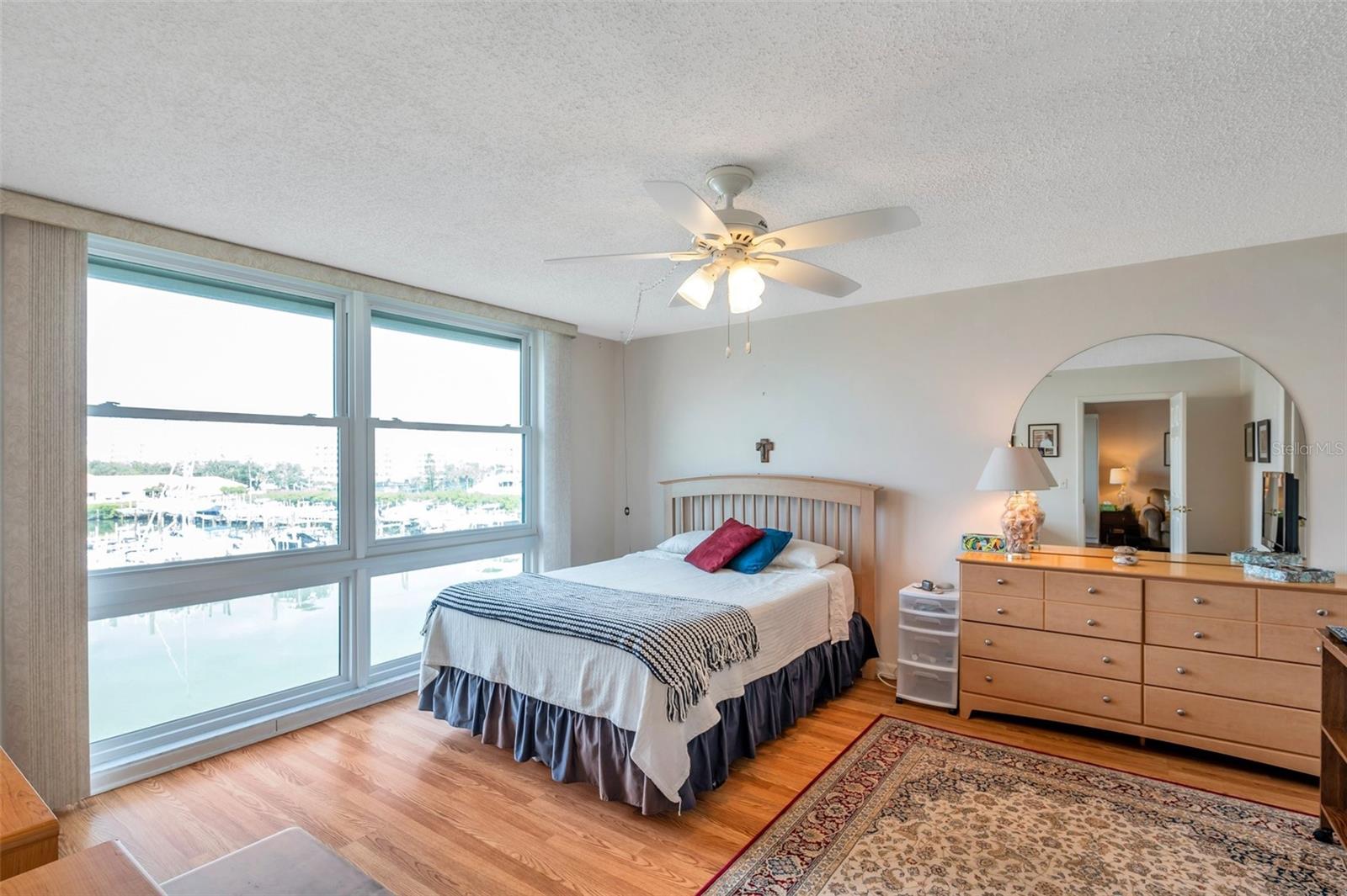 High and dry, beautifully maintained, turn-key, Furnished 1-Bed 1.5-Bath Bay-Front unit with Water Views in the highly sought after 55+ active lifestyle community of Bay Island Condominiums close to St. Pete Beach!! This 4th floor unit has tremendous water views and SUNSETS every night of the year! Unit 407 has high quality impact windows, new washer and dryer in the unit, new refrigerator, newer stove and dishwasher, walk-in closet and a full-size Murphy bed for your family and friends to use when they come and visit you! An open layout leading to the views of Boca Ciega Bay provides a warm and comfortable living environment year-round, or as a seasonal residence. No units in this Presidential building were affected by the past storms. A gated community with a 24-hour guarded gate for all entry. 6 heated pools and hot tubs, bathrooms at the pools, numerous shuffleboards, tennis and pickleball courts. Over 1 mile long walking path on the huge sea wall makes for delightful morning walks, on the water, without leaving the complex!! A huge clubhouse with gyms, saunas, billiards room with 9 tables, library, grilling areas, meeting rooms and a wonderful Marina if you wish to have your boat! HOA includes: Cable TV/Internet, water, sewer, garbage, carport, blanket insurance policy, property upkeep, security and all amenities. Close to shopping, entertainment, beaches, medical facilities and grocery stores. Bay Island Condos are all about living in a high quality, resort style, friendly community. Unit 407 is move-in ready and waiting for you!