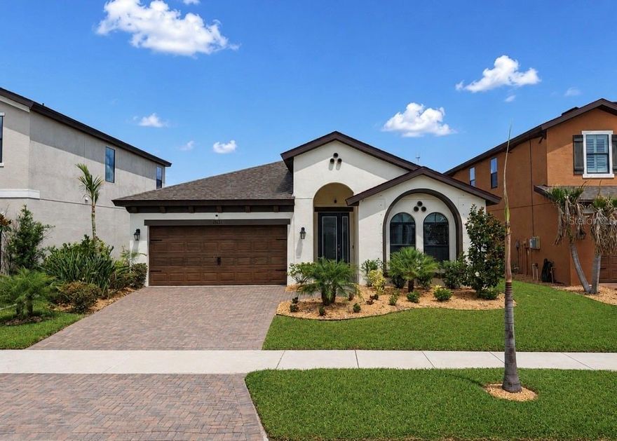 One or more photo(s) has been virtually staged. Welcome home to this BEAUTIFUL 4 bedroom, 2 bath home with a HEATED, SALTWATER POOL AND SPA, offering over 2100 square feet of living space!  From the moment you arrive, you’ll appreciate the EXCEPTIONAL CURB APPEAL with fresh landscaping, decorative rock beds, a paver driveway, and an elegant glass front entry door.  Inside, the CHEF's KITCHEN is a true centerpiece with stylish gray cabinetry, stainless steel appliances, trendy backsplash, pantry storage, and modern pendant lighting overlooking the spacious dining and living areas.  Natural light floods the open-concept living spaces, creating a bright and inviting atmosphere throughout the home.  The PRIVATE PRIMARY SUITE offers a relaxing retreat with a spacious bedroom, TWO large walk-in closets, and a SPA-LIKE ENSUITE BATHROOM complete with dual vanities, a beautifully tiled walk-in shower, and private water closet.  Three additional generously sized bedrooms and a full guest bathroom are thoughtfully located toward the front of the home for added privacy.  Step outside to your own BACKYARD PARADISE — the showstopping feature of this home.  Enjoy year-round outdoor living with a HEATED POOL and SPA, "shell lock" patio pavers, an expansive screened-in lanai, and lush landscaping that creates a peaceful and private setting perfect for entertaining or relaxing.  Located in the desirable neighborhood of Triple Creek, residents are granted access to THREE community swimming pools, a fitness center with group exercise classes, three amenity centers, basketball, tennis, pickleball and sand volleyball courts, an on-site elementary and preschool, walking trails, dog parks, an active social events calendar and so much more!  This home truly offers the best of Florida living inside and out!