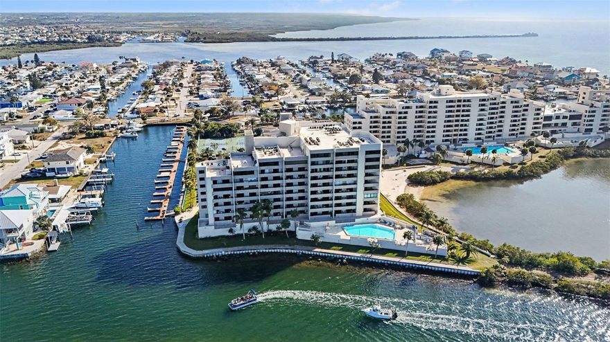 Located at 6035 Sea Ranch Drive, this unit offers a coastal lifestyle in the exclusive, guard-gated Gulf Island Beach & Tennis Club. Residents enjoy a maintenance-free environment with a monthly fee that covers water, cable, internet, trash, and 24-hour security. Resort-style amenities include a heated saltwater swimming pool overlooking the lagoon, a private beach, tennis and pickleball courts, BBQ facilities, and scenic nature trails.

This spacious condo is a rare renovation opportunity, featuring a desirable split-bedroom floor plan with solid bones and water views. It is an ideal canvas for a buyer looking to customize a home to their exact taste. The layout includes a dedicated laundry space and an open living and dining area that leads to a private balcony, accessible from both the main living space and the primary suite. The living room was freshly painted in 2021.

The kitchen was remodeled in 2021 and features black granite countertops, high-gloss white cabinetry, and a sleek metallic tile backsplash. It provides excellent storage with ample cabinets and dual pantries flanking the refrigerator. Additionally, the AC was fully replaced in 2020.

Conveniently located near Hudson Beach, local dining, and SunWest Park, this property serves well as a seasonal retreat or an investment. CASH OFFERS ARE PREFERRED.