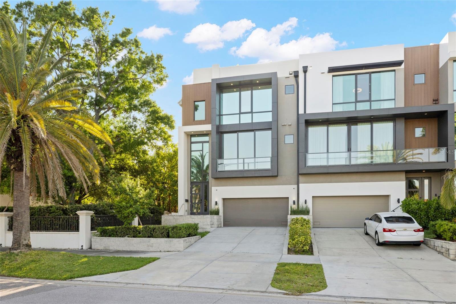 Welcome to 98 W Davis Blvd, an exquisite luxury townhouse nestled in the heart of prestigious Davis Islands in Tampa, Florida. Built in 2022, this exceptional residence exemplifies modern sophistication and convenience, serving as the final masterpiece of acclaimed designer Tommy Lamb. From its meticulously curated details to its thoughtfully designed layout, every element of this home reflects the pinnacle of high-end living. Upon entry, the first floor reveals a versatile bonus room complete with a wet bar—an ideal space for entertaining guests. Adjacent to this is a spacious guest suite featuring an en-suite bathroom with custom built-ins, a dedicated makeup vanity. The second floor is designed for both elegance and functionality, offering a formal living room with a sleek ventless fireplace, a sophisticated dining area, a powder bath, and a chef-inspired kitchen. Outfitted with top-of-the-line Wolf appliances, a Sub-Zero refrigerator, and a stunning waterfall island that comfortably seats four, the kitchen is further enhanced by a striking quartz feature wall, dual pantries, and abundant cabinetry. Nearby, a cozy family room and a glass-enclosed wine room—showcasing the floating staircase—complete the floor. Ascend to the third level where you’ll find another guest suite with a walk-in closet, a dedicated laundry room with dual washer and dryer sets, and a breathtaking master suite. The master retreat features a private balcony, an expansive walk-in closet with sleek black built-ins and gold accents, and a spa-inspired en-suite bathroom. Indulge in the freestanding black soaking tub, oversized shower with multiple heads, and dual vanities designed for both function and flair. For added ease, an elevator services all levels of the home. The two-car garage offers generous space, including room for a golf cart. Retreat to your own private rooftop where you can soak up the beautiful Florida sunsets and enjoy water views perfect for both intimate relaxation and vibrant entertaining. Located on the coveted Davis Islands, this property provides not only a refined lifestyle but also a family-friendly environment. Residents enjoy access to top-rated A+ schools and a vibrant, picturesque community just moments from downtown Tampa. Don’t miss the rare opportunity. Contact us today to schedule a private tour and experience luxury redefined at 98 W Davis Blvd.