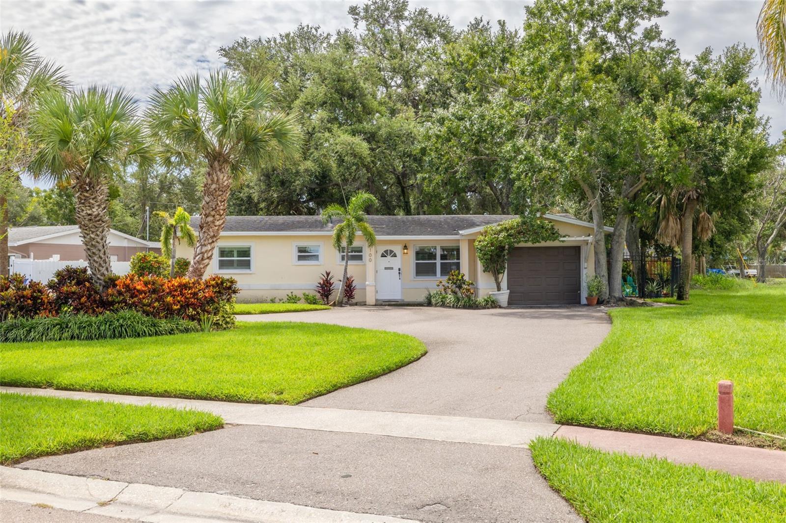Move-in ready and perfectly located on the charming island of Coquina Key! This beautifully updated 3-bedroom, 2-bath concrete block home offers modern living with a tropical waterfront backdrop—without the hassle of waterfront maintenance. Situated adjacent to green space designated as a St. Petersburg city park on the west side of the lot, enjoy uninterrupted views of the canal and green space right from your own backyard. Step inside and fall in love with the sleek, updated interior. The kitchen boasts white soft-close cabinetry, quartz countertops, brand-new stainless-steel appliances, and modern hardware. Gleaming tile flooring runs throughout the home, tying together the open layout with style and ease. The primary suite features an En-suite bath with subway tile, while the second bathroom wows with its designer blue glazed herringbone tile work. Enjoy peaceful mornings on the screened-in back porch overlooking lush landscaping and serene water views. Additional perks include an inside laundry room and a one-car garage for added convenience. This convenient location is just minutes from downtown St. Pete, a short drive to our beautiful Gulf beaches, and walking distance to the Intracoastal and vibrant Coquina Key Park—complete with athletic fields, pickleball courts, a dog park, playground, picnic shelters, and more. This is the best of island living—privacy, views, updates, and location—all in one. Don’t miss your chance to call it home!