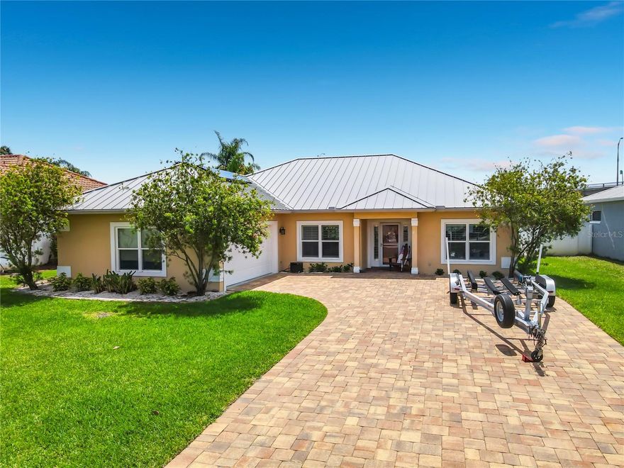 EXPERIENCE TRUE FLORIDA LIVING IN THIS EXCEPTIONAL 3 BEDROOM 2 BATH WATERFRONT HOME WITH A VERSATILE BONUS RM/OFFICE. NESTLED ON A CANAL WITH DIRECT ACCESS TO THE INTRACOASTAL WATERWAY, THIS PROPERTY OFFERS THE PERFECT SETUP FOR BOATING, FISHING OR JUST RELAXING. THE IN-GROUND HEATED POOL & SPA IS IDEAL FOR YEAR ROUND ENJOYMENT ALONG WITH THE COVERED DOCK, BOAT LIFT AND FISH CLEANING STATION. INSIDE IS A DESIRABLE SPLIT FLOOR PLAN WITH A SPACIOUS LIVING AREA THAT FLOWS EFFORTLESSLY INTO THE LARGE KITCHEN, OFFERING GRANITE COUNTERTOPS, ABUNDANT CABINETRY AND AMPLE SPACE FOR GATHERING. CROWN MOLDING AND PLANTATION SHUTTERS ADD AN ELEGANT TOUCH, FRENCH DOORS OPEN TO THE POOL AREA FOR SEAMLESS INDOOR-OUTDOOR LIVING, THE PRIMARY SUITE IS COMPLETE WITH TRAY CEILINGS, EN-SUITE BATH BOASTING A HUGE DOUBLE SHOWER, DUAL SINKS, BEAUTIFUL GRANITE COUNTERS AND A SPACIOUS WALK-IN CLOSET. ADDITIONAL HIGHLIGHTS INCLUDE A SIDE ENTRY 2 CAR GARAGE, PAVER DRIVEWAY, TWO ATTACHED EXTERIOR STORAGE ROOMS, AN INSIDE UTILITY ROOM, SOLAR HOT WATER HEATER AND WHOLE HOUSE GENERATOR, MAJOR UPDATES PROVIDE PEACE OF MIND INCLUDING A METAL ROOF AND SOLAR PANELS REPLACED IN AUGUST 2022, AC UNITS, GENERATOR AND POOL HEATER, REPLACED IN AUGUST 2023 AND POOL/SPA RESURFACED IN DECEMBER 2025. THIS MOVE IN READY GEM COMBINES COMFORT, UPGRADES AND UNBEATABLE ACCESS TO THE INTRACOASTAL.