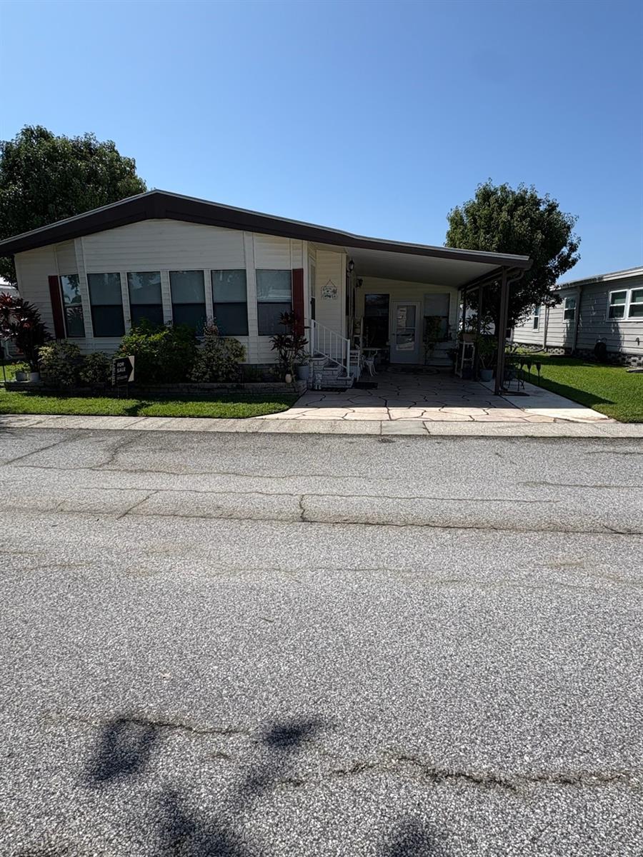 Welcome to this beautifully renovated 3-bedroom, 2-bath mobile home, offering modern comfort, thoughtful updates, and lasting peace of mind. Step inside to an open, airy floor plan with updated flooring, fixtures, and finishes throughout — all installed over a full underlayment for added comfort and durability. The spacious kitchen features all-new cabinets with sleek granite countertops, providing both beauty and functionality, and flows seamlessly into the living area — perfect for entertaining. The split-bedroom layout adds privacy for guests or family.
The master bathroom has been completely remodeled, now boasting a wheelchair-accessible walk-in shower, combining style with accessibility. Enjoy Florida living year-round in the large screened-in porch — ideal for morning coffee or relaxing evenings. One of the standout features of this home is the large laundry room, complete with brand-new cabinets and a working sink, offering excellent storage and utility space. Additional highlights include a durable TPO (Thermoplastic Polyolefin) roof for energy efficiency and low maintenance, and a Generac whole-home generator, providing security and peace of mind in any weather.