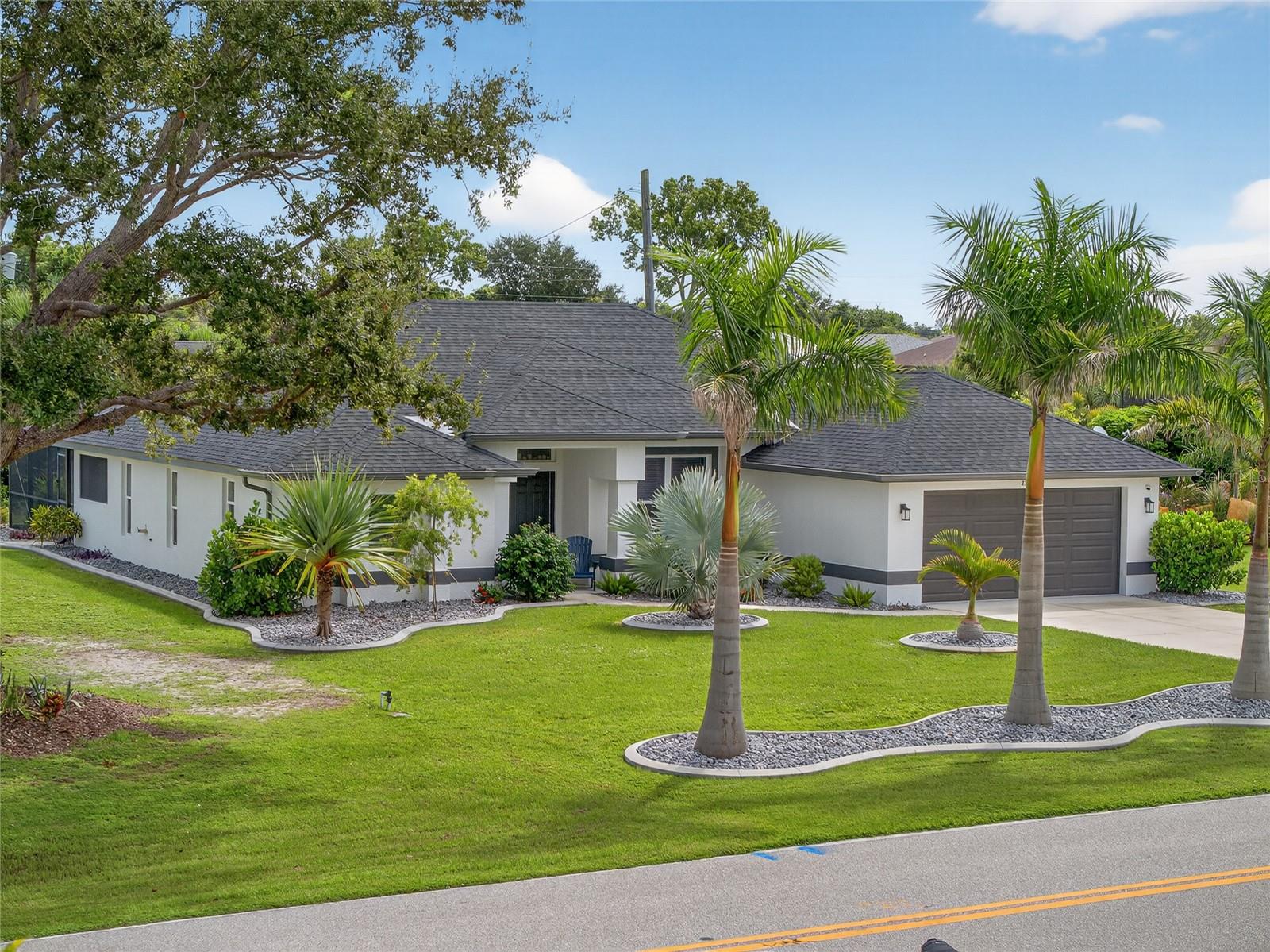 STUNNING CURB APPEAL! LIKE BRAND NEW! BUILT IN 2021 3 BEDROOM, 2 BATH, 2-CAR GARAGE POOL HOME in the deed-restricted community of Burnt Store Village. Step inside where you will find an open floor plan with contemporary décor and lighting, tray ceilings, and ceramic tile throughout. The kitchen offers white raised panel cabinetry complimented by quartz countertops, tile backsplash, stainless steel appliances and large island great for entertaining. Generous primary suite features ample natural light, access to lanai/pool, his and her walk-in closets and private en-suite bath featuring dual sinks, freestanding tub, and walk-in tile shower. Split floor plan provides privacy for guests with two additional bedrooms and separate full bath. Outside enjoy the screened lanai with the saltwater heated pool overlooking the private backyard with greenbelt views. Additional features include a laundry room, hurricane impact windows and doors, irrigation system, hot tub, sun shelf in pool and beautiful lush landscaping. The location of this property is unbeatable, just 20 minutes from downtown Punta Gorda and 30 minutes from downtown Fort Myers. Additionally, it's close to the relaxed waterfront community of Burnt Store Marina, offering access to resort and golfing facilities, waterfront dining, and entertainment. It is conveniently located to the airport, restaurants, shopping, beaches, and award-winning fishing and boating. Don't miss out on this opportunity! Schedule your private showing today!