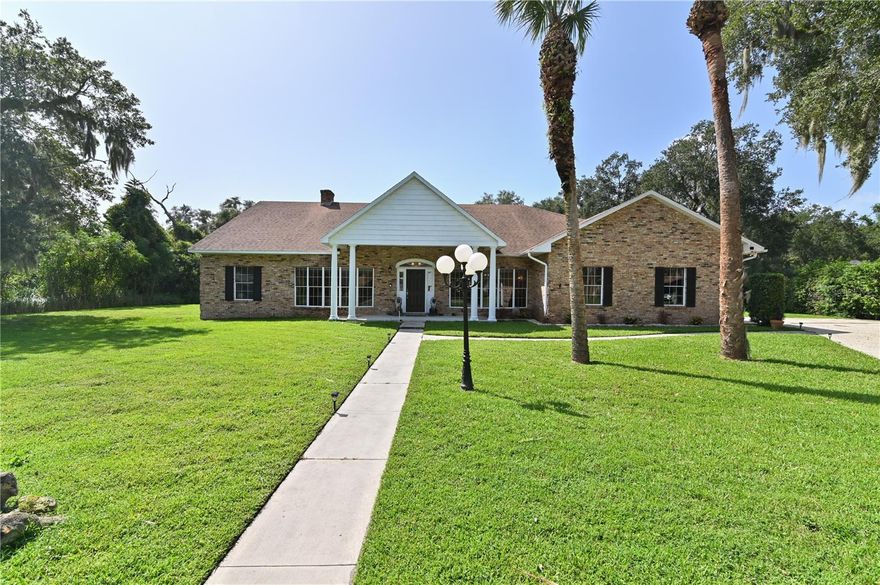 Discover the allure of this impeccably maintained 4-bedroom, 3-bathroom pool home nestled in the exclusive enclave of Hidden Harbor. The timeless elegance of the brick front exterior, adorned with four grand pillars, sets the stage for a residence that exudes sophistication.

Step into a sunlit haven with a split floor plan, featuring a sunken living room and an expansive lanai and pool deck—an entertainer's dream. The generously sized pool, a rarity in today's homes, beckons relaxation and recreation.

Every bathroom in this residence has undergone exquisite updates, reflecting a commitment to modern luxury. The large front entry welcomes you, leading to a formal living room and dining room adorned with bay windows, allowing natural light to dance through.

Crown molding graces the front entry, formal areas, and kitchen, creating an ambiance of refined charm. The family room, boasting a wood-burning fireplace and and optional decorative electric logs, is a cozy retreat.

Explore further into the left wing, accessible via a convenient pocket door, where a guest bathroom with a walk-in shower awaits. Two bedrooms in this wing, one featuring a spacious walk-in closet and an en-suite bathroom with direct access to the pool area, offer a private retreat for guests.

The heart of the home unfolds in the kitchen and breakfast nook, featuring granite countertops, deep double sinks, built-in oven, microwave, and ample storage. Freshly painted and updated, this space seamlessly connects to the large dining room through a pocket door.

Venture to the other wing housing the master bedroom suite, a fourth bedroom, laundry room, and garage—accessible through another pocket door. The master bedroom, which opens to the pool deck through French doors, leads to a master bathroom oasis. Immerse yourself in luxury with a spa garden tub, a walk-in shower with a multifunction panel, and a custom closet.

French doors from the fourth bedroom open to the driveway, providing a versatile space. A large laundry room with sink and cabinets completes this wing.

Situated on over half an acre, the property offers ample space for family activities or serene relaxation. The oversized two-car garage, with side entry and exterior windows, ensures a well-lit space with its own entry door.

Finally, step into the oversized pool area, featuring a covered lanai with a bar area, skylights, and ample seating space. The expansive pool deck, sundeck, outdoor shower, and a deep pool, all within a screened room, create a private oasis surrounded by a natural fence line.

Notable updates include a roof replacement in April 2018, whole-house replumbing in January 2015, and bathroom renovations between 2018 and 2022. Electric blinds enhance the living spaces, and a storage shed was added in 2020. In addition, there is a whole house vacuum system. Seize the opportunity to call this Hidden Harbor gem your own.