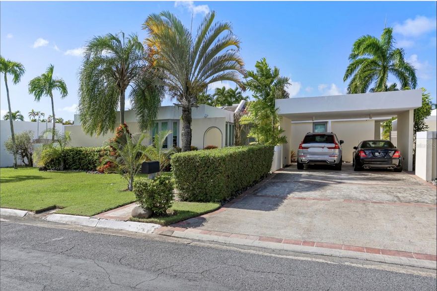 Discover this exceptional single-family residence in the desirable Vistamar Marina Este community, offering direct canal access to Laguna La Torrecilla and the Atlantic Ocean, an ideal setting for boating enthusiasts. This spacious 3,200 sq ft home sits on a one thousand square meter lot and features four bedrooms, three and a half bathrooms, and newly updated floors in the living and dining areas. The extended kitchen is designed for entertaining, flowing seamlessly into a covered terrace and a sparkling 20' x 30' pool overlooking the water. A private 100-foot concrete dock provides convenient canal access suitable for various boat types. Additional amenities include a 20KW diesel generator, 600-gallon water cistern, semiannual CRIM of approximately $1,300, and a low monthly HOA fee of $125. Located in a tranquil gated community just 10 minutes from the airport and 15 minutes from Condado, this home offers the perfect blend of privacy, comfort, and coastal living.