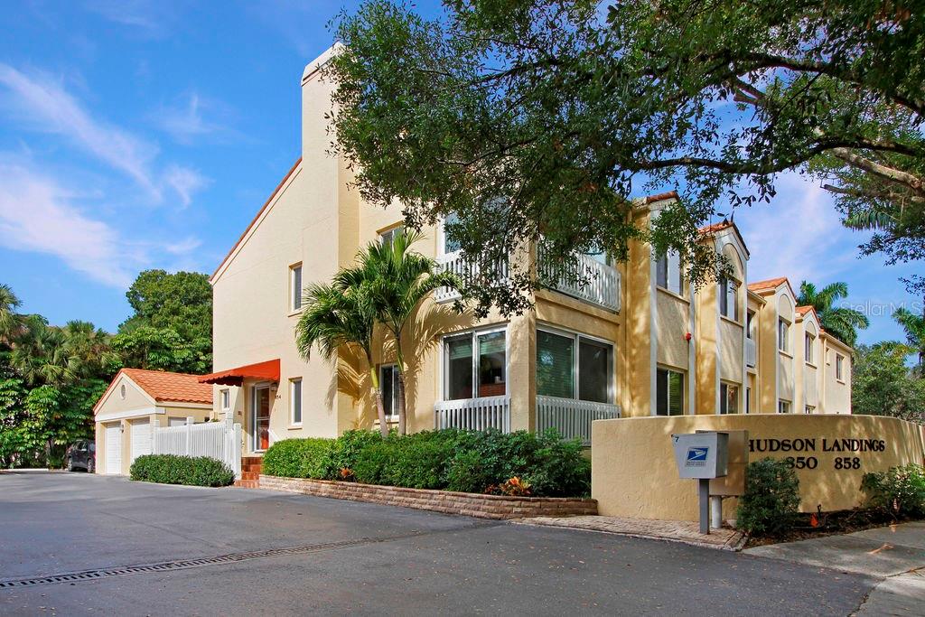 Experience the best of both tranquility and walkability to Downtown Sarasota in this west of the trail second floor condo. This beautifully renovated condo is available as an unfurnished annual rental and features 2-bedrooms, 2-bathrooms with den/3rd bedroom option is an incredible opportunity to live a few minutes from the bay, the marina, and downtown. This single level, corner unit has plenty of natural light and has been totally updated with features such as exposed-beam vaulted ceilings, large shower, contemporary light fixtures, and a wood burning fireplace. Enjoy other features such as custom kitchen cabinets, glass tile backsplash, newer granite countertops, and top of the line stainless appliances including built-in double oven and glass cooktop. The patio has been enclosed with large hurricane-proof sliding windows creating a bright dining area with a peek of the Hudson Bayou. This location offers a unique lifestyle and is walkable to Marie Selby Botanical Gardens and the beautiful Sarasota Bayfront and Marina. Hudson Landings is one of Sarasota's best kept secrets, with 12 residences tucked into a private, calm, and secluded location. This is an absolute must see. Community pool is heated.