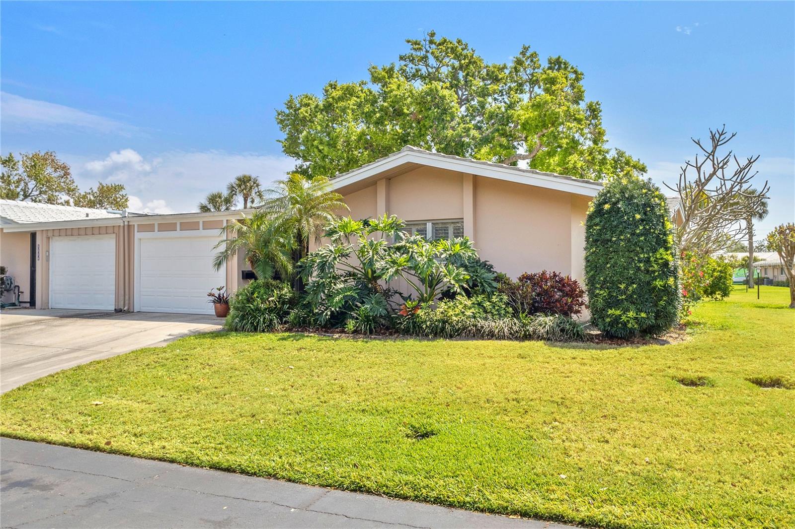 Discover a meticulously maintained 2 bed/2 bath villa in the tranquil 55+ community of Village Green in Sarasota. Tucked away on a private dead-end street, this home provides the comfort and exclusivity of a single-family residence with an expansive layout that includes separate living, dining, and Florida rooms—ideal for both relaxation and entertaining. The well-appointed kitchen is a chef’s delight, featuring generous counter space, abundant cabinetry, deep set pantry, a built-in desk, and room for a cozy bistro set. There's also a large indoor utility room complete with a laundry sink and coupled with a walk-in closet outfitted with extensive shelving and additional cabinets, ensuring that every storage need is met. For added convenience, the separate entrance from the garage to the kitchen makes it easy to transfer groceries from the car. Wood plantation shutters adorn the windows in both bedrooms and large windows throughout the home provide plenty of natural light. The screened patio overlooking a lush greenbelt is a perfect haven for your morning coffee or a great spot to unwind at the end of the day to enjoy the warmth of sunset. Maintain an active lifestyle with the quarter-mile loop right outside your back door, designed for getting your steps in along the picturesque Village Green. Just two doors down, the community pool and ramada create a welcoming setting for neighbors to gather and socialize. Experience a maintenance-free Florida lifestyle at an attractive price, with shopping centers, dining, hospitals, and beautiful beaches all within easy reach. Don’t miss your chance to join this vibrant, active community in the heart of Sarasota—schedule your private tour today and experience the charm of Village Green living!
