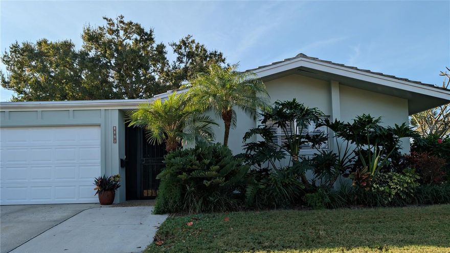 Discover a meticulously maintained move-in ready 2 bed/2 bath villa in the tranquil 55+ community of Village Green in Sarasota. Tucked away on a private dead-end street, this home provides the comfort and exclusivity of a single-family residence with an expansive layout that includes separate living, dining, and Florida rooms—ideal for both relaxation and entertaining. AC replaced in 2020, new water heater 2025, flat roof over garage replaced Sept. 2025 with transferable warranty and exterior painted Dec. 2025.  The well-appointed kitchen is a chef’s delight, featuring generous counter space, abundant cabinetry, deep set pantry, a built-in desk and room for a cozy bistro set.  There's also a large indoor utility room complete with a laundry sink and coupled with a walk-in closet outfitted with extensive shelving and additional cabinets, ensuring that every storage need is met.   For added convenience, the separate entrance from the garage to the kitchen makes it easy to transfer groceries from the car.  Wood plantation shutters adorn the windows in both bedrooms and large windows throughout the home provide plenty of natural light.  The screened patio overlooking a lush greenbelt is a perfect haven for your morning coffee or a great spot to unwind at the end of the day to enjoy the warmth of sunset.  Maintain an active lifestyle with the quarter-mile loop right outside your back door, designed for getting your steps in along the picturesque Village Green. Just two doors down, the community pool and ramada create a welcoming setting for neighbors to gather and socialize.  Experience a maintenance-free Florida lifestyle at an attractive price, with shopping centers, dining, hospitals, and beautiful beaches all within easy reach. Don’t miss your chance to join this vibrant, active community in the heart of Sarasota—schedule your private tour today and experience the charm of Village Green living!