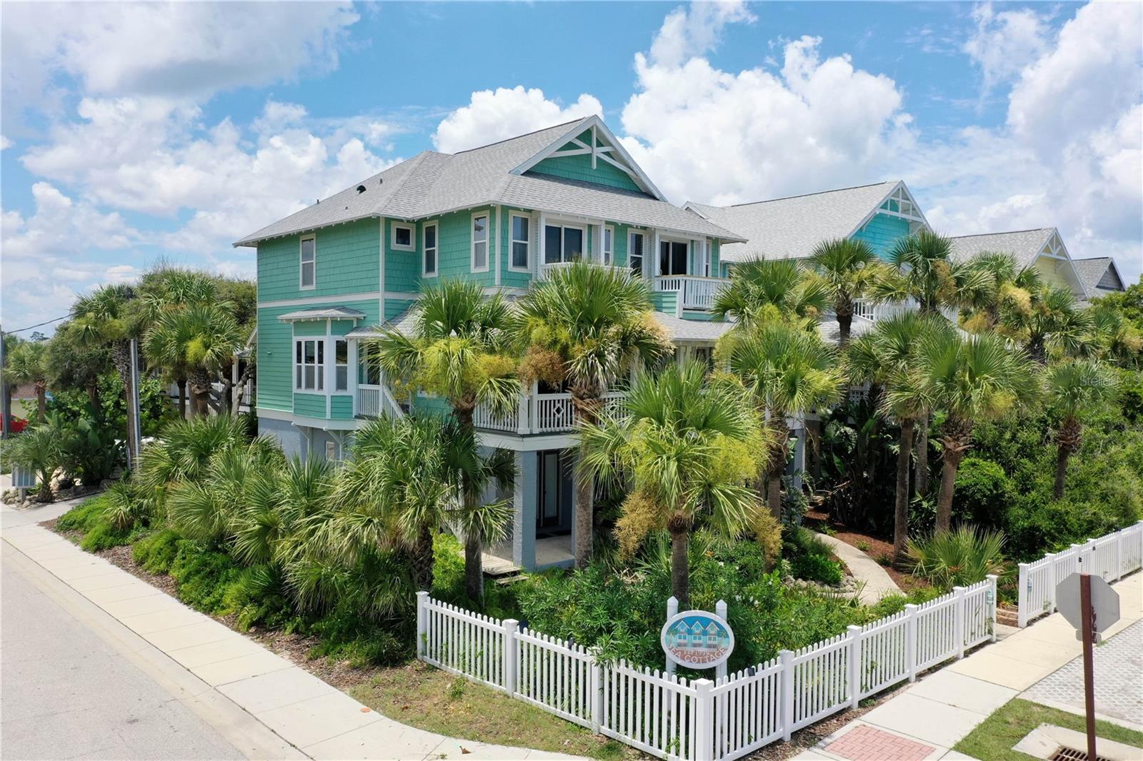 One or more photo(s) has been virtually staged. Charming Coastal Cottage Living and Just One Block from the Ocean!
Welcome to 612 S Central Ave, part of the beloved Flagler Sea Cottages locally known as the "Painted Ladies" of Flagler Beach. This enchanting 3-story home is full of coastal character and modern charm, wrapped in a white picket fence with a beautifully landscaped courtyard and a winding path that leads you just one block to the sandy shoreline. Tucked on the corner of Central Ave and 6th Street, this is one of only three homes in an exclusive seaside enclave, with private driveway and garage access from the 6th Street side.
Step into the ground-level suite with its own entrance perfect for guests, in-laws, or even a private office and complete with a full bathroom, walk-in shower, and a covered patio oasis. Inside entry is also available from the garage or via the outdoor staircase leading to the main living space on the 2nd floor. Upstairs, enjoy a light-filled open concept living area with fireplace, dining space, and a well-appointed kitchen featuring an island, glass-front cabinetry, and pull-out shelving. Sliding glass doors open to an East-facing covered balcony with ocean peek views, perfect for sunrise coffee while the West-facing balcony off the kitchen captures golden sunset skies. The 3rd floor is where the coastal magic truly unfolds. The primary suite boasts an ensuite bath with dual vanities and a jetted soaking tub, plus direct access to a private open-air balcony with sweeping views towards the Atlantic. A laundry closet and an additional guest bedroom with its own ensuite bath and west-facing window views complete the top floor. Freshly painted outside and complete with an outdoor shower for rinsing sandy toes, this home blends beachy elegance with laid-back Florida living. Don’t miss your chance to own a piece of iconic Flagler Beach charm—schedule your private showing today!