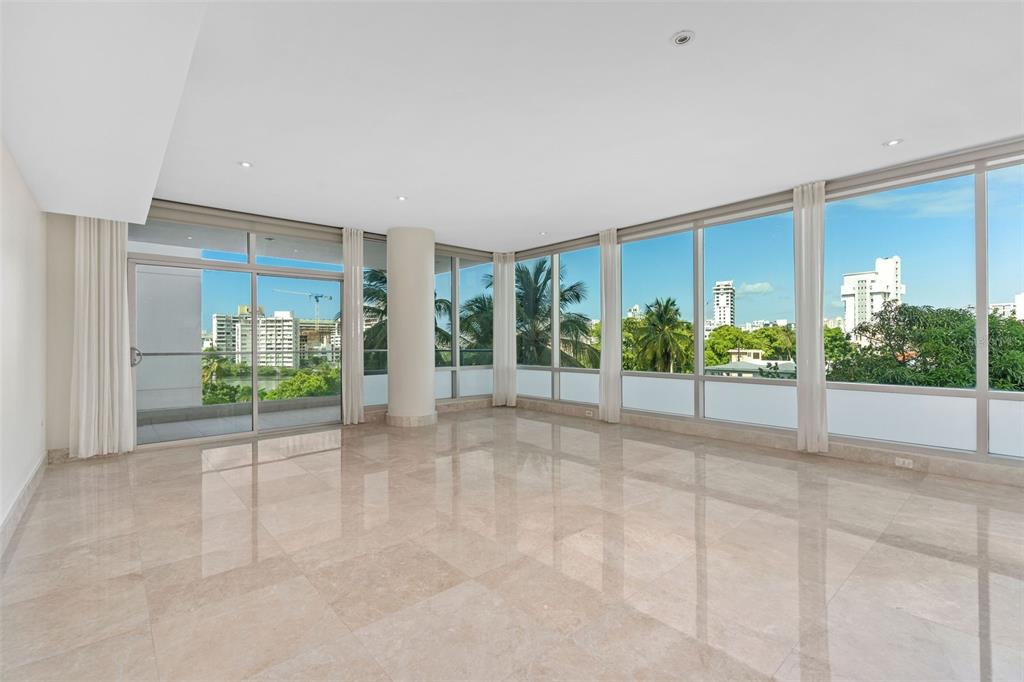 Presenting luxury living in a beautifully appointed 3 Bedroom, 3.5 Bathroom condo at the award- winning, full service Cosmopolitan Condominium. The expansive 2,500 SF residence is a Miramar gem in pristine condition and ready for the new owner to transform it into the perfect home.
Lounge in the expansive living room filled with sunlight from the plethora of floor to ceiling windows throughout or walk out to the private balcony and enjoy the lovely views of the city and Condado Lagoon.
The open chef’s kitchen is perfect for entertaining featuring a warm color palette, granite countertops, elegant cabinetry, a free-standing oversized island and top of the line stainless steel appliances. Adjoining is the formal dining room including a dry bar with a wine fridge and additional cabinetry allowing for an easy set up to host fabulous cocktail parties.
Unwind in the spacious primary bedroom suite, boasting two walk-in California closets, and a large ensuite bath with spacious and separate double vanities, a shower and whirlpool bathtub.
Amenities include a grand lobby with 24/7 concierge services and security, an entertainment lounge, an outdoor infinity pool, a fitness center and conference room. The Cosmopolitan Condo has 2 full power generators, a water cistern and hurricane proof glass windows throughout. The purchase includes 2 parking spaces and 1 storage unit.
Get informed about Puerto Rico’s Act 60 Tax Incentive Program. Let us help you call this beautiful island HOME. Learn More: https://www.taxincentivespuertoricoinfo.com/