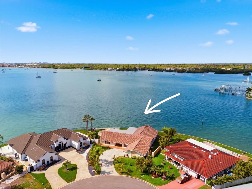 One or more photo(s) has been virtually staged. Exceptional Open-Water Home in Broadwater | 160 Ft Wide Waterfront

Experience breathtaking waterfront living in this extraordinary open-water residence located in the
exclusive boating community of Broadwater in St. Petersburg. Situated at the end of a quiet cul-de-sac
on an oversized 0.41-acre PIE SHAPED lot, this rare property boasts 160 feet of wide frontage on Boca
Ciega Bay with sweeping 270-degree panoramic water views and quick access to the Gulf of Mexico. The
huge back yard provides the new owners with endless possibilities. Nicely ELEVATED LOT with no
flooding history, this beautifully high quantity constructed residence offers 4 bedrooms, 3 bathrooms,
and over 3,900 square feet of cooled living space designed to maximize stunning water views from
nearly every room and privacy from neighbors. The spacious 3-WAY split open floor plan features
multiple living and entertaining areas and separated formal living room and dining room near the front
of house. Soaring 13-foot vaulted ceilings in the family room and two bedrooms. A wood-burning
fireplace and walls of floor-to-ceiling windows of family room at the back of house that enhance the
home with natural light and showcase the expansive OPEN WATER VIEW. The home is finished with
polished mirror-like marble flooring, elegant built-ins with wine storage, and a timeless neutral palette
throughout. A 520-square-foot gourmet kitchen serves as the heart of the home, featuring a center
island beneath a large skylight, decorative ceilings, crystal chandeliers, a large pantries, stainless steel
appliances, glass cooktop, designer range hood, approximately 110 square feet of granite countertops,
three sinks, and a sunny breakfast nook. The waterfront primary suite offers spectacular views, a walk-in
closet, spacious walk-in shower, and private water closet. Additional baths include a luxurious marble
bath with jetted tub and a convenient pool bath with outdoor shower. Step outside to a resort-style
setting where a 34 X 16 resurfaced pool is surrounded by a stunning imported natural onyx paver deck.
Along the seawall, a massive 900-square-foot concrete waterfront landing provides endless possibilities
for entertaining, sunbathing, fishing, or relaxing by the Bay. The home is topped with a BRAND NEW
2025 MULTI-COLOR CONCRETE TILE ROOF and framed by lush tropical landscaping with mature palms
and fruit trees. Numerous updates include newer air conditioners, water heater, pool surface and ONYX
decking, epoxy garage floor, updated kitchen and bathrooms, interior finishes and exterior paint, making
the home move-in ready.The previous dock and lift permits remain on record with Pinellas County and
the City of St. Petersburg, allowing for an expedited dock replacement permitting process. The new
owners can build the dock along the incredible 160 FT of seawall. Enjoy unforgettable sunsets, holiday
boat parades, and fireworks over the Bay from your backyard while embracing the ultimate Florida
waterfront lifestyle. Conveniently located just minutes from The Vibrant Downtown St. Petersburg
which is loaded with Exceptional Dining, Museums, Art, the St. Pete Pier, the Tampa Bay Rays Baseball,
Gulf beaches, I-275, and St Petersburg and Tampa International Airport, this remarkable property offers
a rare opportunity to own one of Broadwater’s most spectacular waterfront homes. Catch the
most stunning sunset from inside and outside of house and watch dolphins swim by.