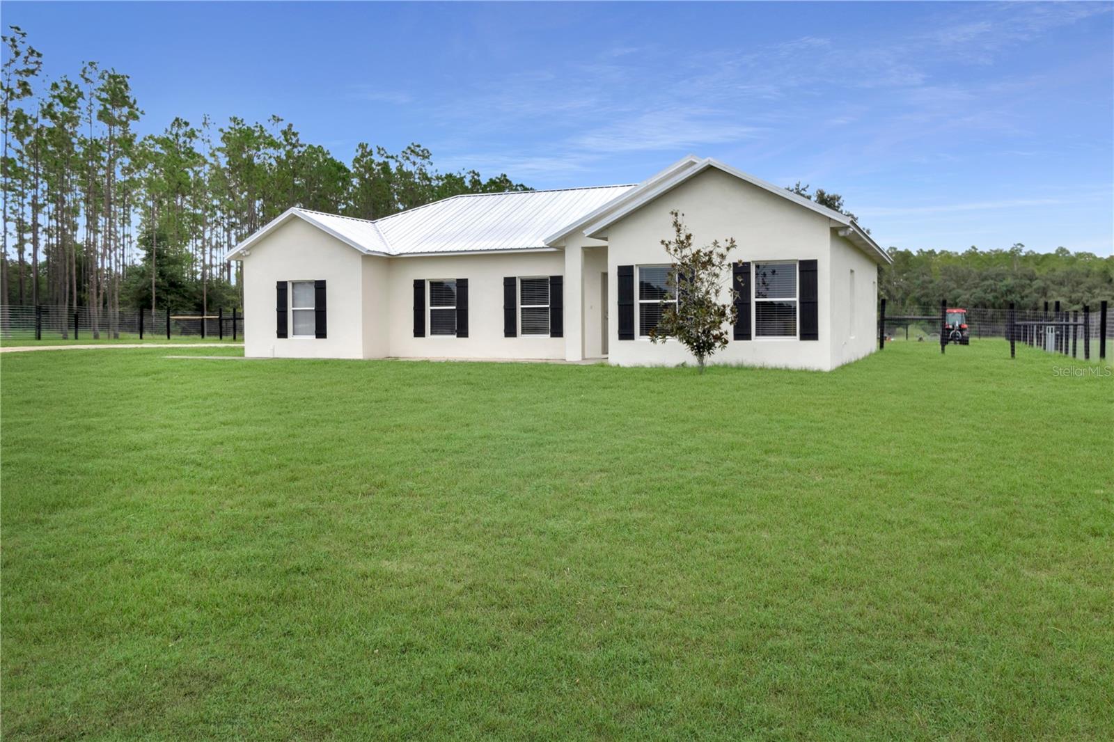 Escape to country living with this 3 bedroom, 2 bathroom single-story home with attached 1-car garage on 10 acres with 5 fenced acres. Thoughtfully maintained, the property is secured with cross-fencing and durable 5’ no-climb fencing with over 350 freshly painted posts (2025).
The home has received numerous updates for peace of mind: metal roof (2022), AC system (2020), water heater (2025), well tank (2024), septic pumped (2022), French doors with built-in blinds (2023), and new garage door opener and entry door (2025). Bedroom 2 features new carpet (2025), and the kitchen includes a dry bar area that could easily be converted back to a laundry space with plumbing ready behind the backsplash.
A highlight of the property is the 1,232 sq ft (30x42) metal building built in 2022, complete with a 6” slab, three bays, and endless possibilities for storage, workshop, or hobby space.
Additional features include new exterior flood lights, a replaced disposal (2022), and plenty of space for outdoor living.
With no HOA, this property offers privacy, functionality, and room to grow—perfect for those seeking a blend of comfort and country lifestyle.
