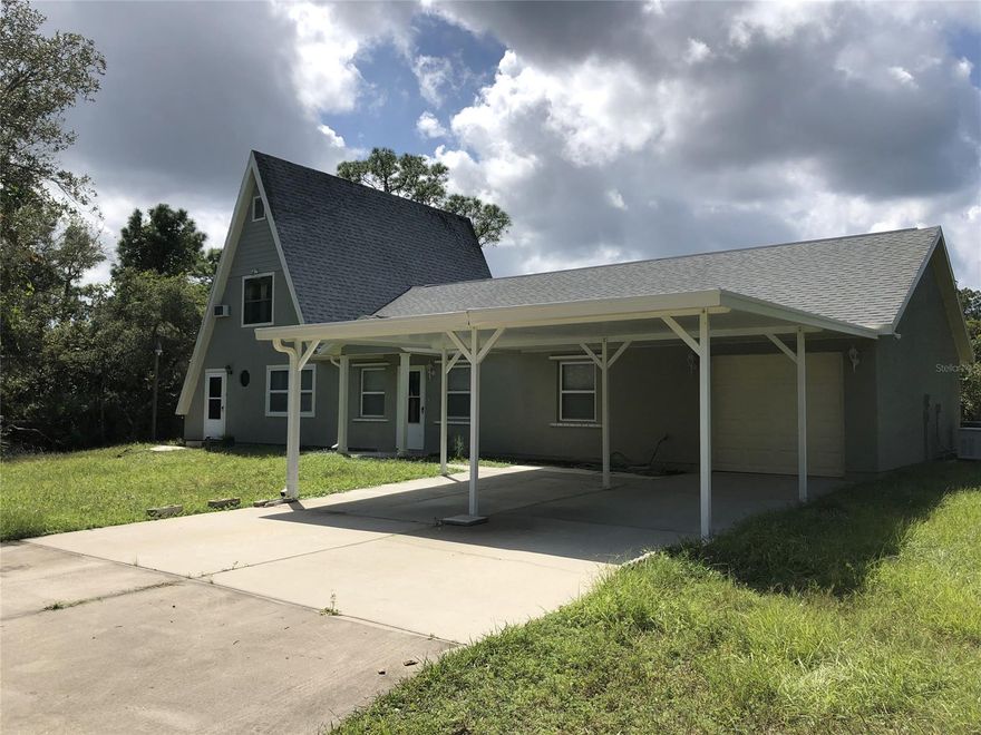 4 Bedroom, 2 Full Baths, 2 Half Baths, 1 Car Garage, with two carports!  This house is 2259 SF under air! Located on 2.5 acres of land. Roof is from 2007.  Has a detached 40x30 metal garage with an office inside it that has A/C and Electricity.  House has an open floor plan with tons of natural light.