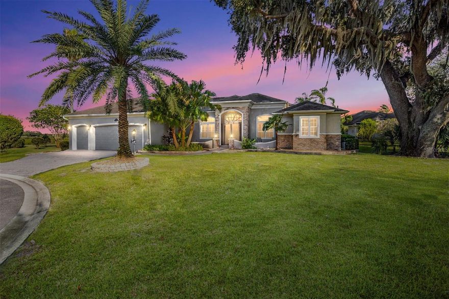 ICONIC, STUNNING, UNIQUE and ONE-OF-A-KIND only begin to describe this expanded St. James Premier home with over 5400 SF of air conditioned living space with 5 bedrooms and 4 ½ baths.  The oversized ¾ acre lot is located directly on Lake Sumter in the prestigious Village of Bridgeport at Lake Sumter.  Enjoy the convenience of a 5-minute golf cart ride to Lake Sumter Landing or the practice facilities at Palmer Legends Golf Course.  Take in the panoramic views of Lake Sumter and the 6th & 7th holes of the Riley Grove Golf Course at Palmer Legends. There are three master suites and each has elegant en-suite baths with Roman Showers, granite counters and large walk-in closets.  The two-story Atrium, with floor-to-ceiling windows and a magnificent Italian Quartz wall sculpture, has a beautiful red oak staircase leading to an upstairs Master Suite, Office, or Art Studio, you decide. This suite has incredible views of Lake Sumter and a screened balcony. 
The family room has floor-to-ceiling sliding glass doors that open to a massive lanai and pool area.  Audio and energy saving LED lighting have been added throughout the main living areas and the lanai.  Updated light fixtures and ceiling fans contribute to the soft contemporary style.  Six TV’s and 3 surround sound systems are included with the home.  The covered lanai is a perfect entertainment area for large or small gatherings at over 750 square feet and includes a built-in summer kitchen featuring granite counters and backsplash, a Twin Eagles grill, Kamado Joe smoker, wet bar with refrigerator, and commercial icemaker with a rated capacity of 240 pounds of ice per day. Breathtaking views highlight the solar and gas-heated spa and pool with 3 waterfalls.  The gourmet kitchen features updated Kitchen Aide, Miele and Cafe stainless steel appliances, granite counters, a gas range with baking drawer, microwave with air fryer and convection capabilities and a closet pantry. This home will exceed your expectations for both entertaining and living. Two additional downstairs bedrooms share a Jack & Jill bath with granite counters.  The flooring is Italian porcelain tile and engineered, scraped hardwood throughout. Window treatments are all plantation shutters.  Crown molding everywhere even including the lanai.  Twelve-foot ceilings create an open and spacious feel. There is a whole home water softener, lightning rod protection, brand new roof and huge amounts of built in storage space in the garage.  With well over 5,000 sq. ft. of air-conditioned living space and massive outdoor living areas, this magnificent home is unlike anything else in The Villages. It can be yours but don’t wait. Make your appointment for a private tour today. (Bond Payoff $17,864.46; Annual Bond payment $1,830.74; Annual Bond Maintenance $1,122,37.)