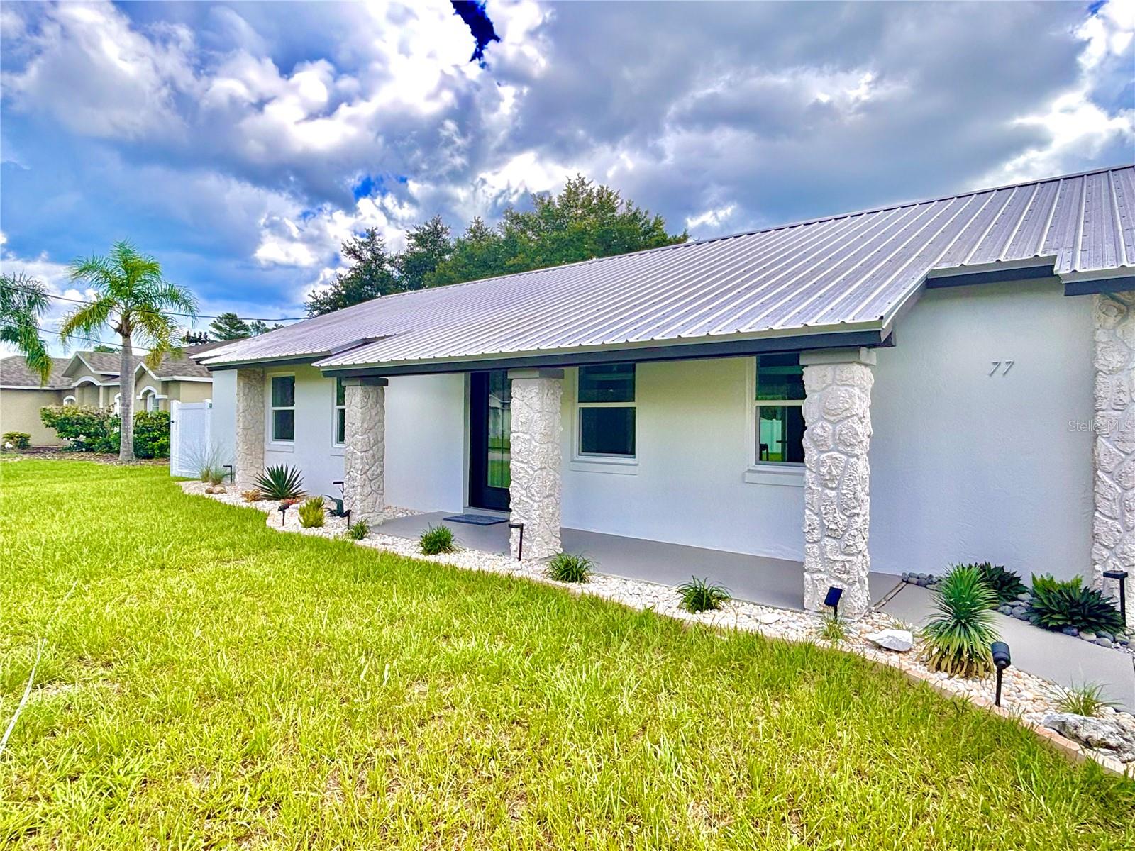 One or more photo(s) has been virtually staged. LOCATION, LOCATION, LOCATION –NO HOA or CDD Fees! Step into this newly renovated, thoughtfully designed block-construction home in the sought after Palm Harbor “F” section – and feel like you’ve just arrived on vacation. From the moment you enter, the open, airy layout and high-end finishes invite you to relax and unwind. Ideally located less than 3 miles from two I-95 exits, you're just 30 miles from Daytona Beach, 28 miles from St. Augustine, and only 5.4 miles from the Atlantic Ocean. Everyday convenience is at your fingertips, with Publix, Home Depot, Lowe’s, Starbucks, Dunkin' Donuts, Planet Fitness, banks, restaurants, and retail options all within less than a 3 mile radius. Nature lovers and outdoor enthusiasts will appreciate over 130 miles of walking and biking trails, multiple golf courses, parks, and beautiful beaches. Zoned for top-rated schools (Old Kings Elementary, Indian Trails Middle School, and Matanzas High School), and with a school bus stop just steps away, this location truly checks all the boxes. Inside, premium porcelain tile flows throughout the spacious floor plan. The heart of the home—the newly updated kitchen—features brand-new LG appliances, soft-close Kraftmaid cabinets, exquisite Caesarstone quartz countertops, a marble backsplash, and a functional workstation sink. The kitchen is illuminated with indirect lighting for ambiance, task lighting to support your culinary adventures, and a soft night light—all on dimmers to set the perfect mood any time of day. Unlacquered brass hardware adds a designer touch to this elevated space. Step outside to your expansive, fully fenced 4,000+ sq ft backyard—ideal for entertaining or peaceful evenings at home. The upgrades throughout this home speak to quality and comfort: Custom California Closet in the primary suite, Updated bathrooms with backlit, anti-fog mirrors, 2018 metal roof and Carrier HVAC for efficiency, 2023 garage door and 2025 opener,?Newly upgraded 55-gallon WiFi-enabled water heater, 2024 privacy vinyl fencing, new sod, and fresh landscaping, 2024 upgraded attic insulation for comfort and energy savings, Modern new front door and mailbox for strong curb appeal and more. This is a rare opportunity to own a home that blends luxury, location, and low-maintenance living—perfect as your primary residence, vacation retreat, or investment property. Don’t miss your chance to call this exceptional home yours. Schedule your showing today!