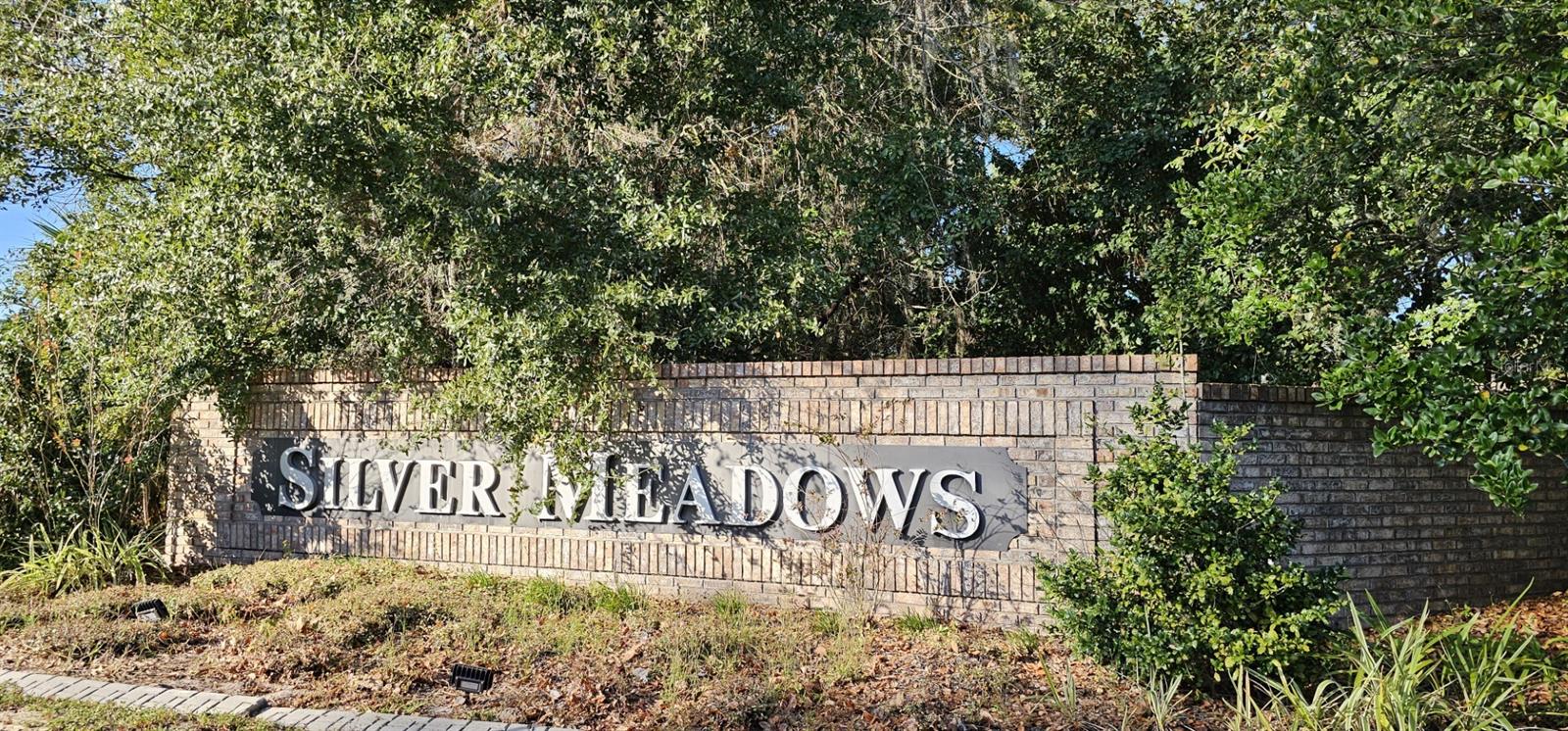 From the moment you arrive, you will be captivated by the peaceful and inviting ambiance that Silver Meadows North offers. The meandering road, lined with majestic oak trees, sets the tone as it leads you to a spacious vacant lot measuring 1.24 acres. Unlike busy city streets, this community embraces a natural and enchanting charm, with no street lights or curbs, allowing you to truly immerse yourself in the picturesque surroundings. As you take the time to explore the community, you will discover the charm and elegance that Silver Meadows has to offer. Stylish homes are nestled on large lots, each showcasing distinctive designs. With this vacant lot, you have a golden opportunity to design and build your dream custom home, tailor-made to your exact specifications and preferences. One of the many highlights of this community is the central location of the Recreation Centers within the Community. At the heart of Silver Meadows, you'll find one of two Recreation areas, offering an array of amenities such as tennis, basketball, and racketball. Additionally, the lush green spaces provide the perfect setting for a leisurely picnic or outdoor gathering, creating a sense of community and enjoyment for residents. Bid farewell to the cramped quarters of city living and embrace the space and tranquility that this large lot in Silver Meadows offers. With its rural ambiance, gated community, and abundant recreational amenities, this vacant lot presents an exceptional opportunity to create the perfect retreat for you and your loved ones. Don't let this chance slip away – contact us today for more information and to schedule a viewing. Let us help you turn your dream of building a home in this sought-after location into a reality. Silver Springs State Park, Silver Springs Nature Theme Park, Ocala National Forest, Silver Springs Shores Golf & Country Club, Historic Downtown Ocala, Silver Springs Museum and Environmental Education Center, and Local Equestrian Facilities. These additional points of interest showcase the diverse recreational, cultural, and natural attractions that make Silver Springs, Florida an attractive location for potential home buyers