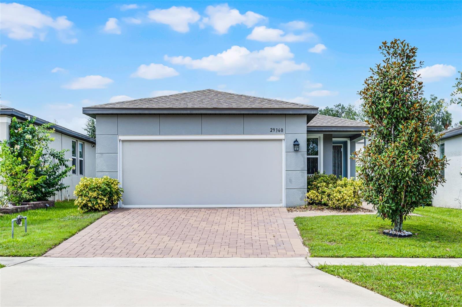 This beautifully designed 4bedroom, 2bath home in Lake Denham Estates offers comfort, convenience, and style all in one. Set within one of Lake County’s newer communities, the location places you just minutes from local grocery stores, restaurants, and the Lake Harris Chain of Lakes, perfect for weekend adventures or everyday errands. Step inside to find a thoughtfully planned Olympic floor plan featuring an open-concept layout and tasteful finishes throughout. The kitchen is a standout with its quartz countertops, spacious center island, gas range, and 42" upper cabinets with pull-out shelves offering both beauty and practicality. You'll find ceramic tile in the main living and wet areas, while plush carpeting adds warmth to each bedroom. Smart home features enhance everyday living, including a Bluetooth-enabled AprilAire thermostat (app required), a smart garage door opener, smart entryway lighting, and a Ring doorbell. Additional upgrades include five remote-controlled ceiling fans, a motorized roll-up garage screen, and pavered walkway and driveway. There's also an indoor laundry room, and the garage refrigerator stays with the home. A termite bond with Massey Pest Control provides peace of mind. The community itself offers great amenities such as a resort-style pool and a convenient outdoor workout space. Located just 30–45 minutes from Orlando’s top attractions, this home is a perfect blend of modern comfort and Florida lifestyle.