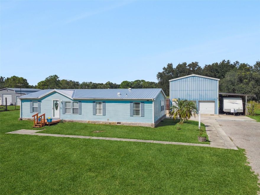 Spacious 3BR/2BA doublewide manufactured home on a beautifully cleared and usable 2.43-acre lot, offering room to roam, garden, park your toys, or simply enjoy peaceful country living. This property includes an oversized Florida room overlooking a gorgeous inground pool, perfect for relaxing, entertaining, or enjoying year-round views of your private backyard oasis.
Outside, you'll find a detached garage/workshop with 3 bay doors, ideal for hobbies, vehicles, or storage, plus a covered carport perfect for a camper or boat.
The split, open floorplan features updated flooring throughout most of the home (2021), added kitchen cabinetry (2021), new sliding glass doors (2022), and a new metal roof (2025). Additional updates include: new septic drain field (2020), new well pressure tank (2022), new front porch (2023), and updated fencing (2024). Exterior side door to Florida room was just recently replaced in 2025.
Whether you're looking for space, functionality, or the perfect entertaining setup—this property checks all the boxes. Come see it today!