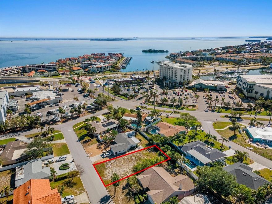 Great opportunity to build!  Current elevation estimated at 9'.  (Home on lot that next block over with 9' elevation did NOT flood in either storm.) Owners plan was to grade up to 11' elevation and still have one story home on this lot.  (Similar home recently built nearby).  This lot is unique as it has an INCREDIBLY HIGH WALKABILITY SCORE; so close to great restaurants (The Island Grille and Raw Bar, Circo's Italian Restaurant).  Also close is a convenience store, liquor store, hair salon, and gas stations and a Subway; a great stop to grab some sandwiches before stepping onto your boat!  Yes, the local HIGH AND DRY MARINA is also just a few steps away; SOOOO easy for boating.  This is such a UNIQUE opportunity to live in a BEAUTIFUL waterfront community without being directly waterfront, and just a short drive from more restaurants as well as FT DESOTO PARK! Listing Agent is owner.