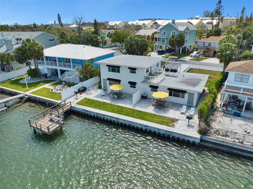 Welcome to your very own tropical waterfront oasis, a wonderful Triplex with three 2 bedroom/ 1 bath units all with breathtaking views of the inter-coastal waterways of Indian Rocks Beach. Imagine the tranquility of enjoying your morning coffee on the Rooftop Deck while watching the sunrise. Only a short walk to the beach where you can enjoy countless hours soaking up the sun and letting the waves wash your worries away, when you make your way back to your tropical oasis, rinse of the sand with the convenience of the outdoor shower. The backyard is perfect for entertaining with an outdoor grill, new pavers, and a dock as an added hangout spot where you can enjoy fishing or just enjoy watching the clouds change colors as the sun sets.  Beautiful and Simplistic landscaping, fully equipt with sprinklers and fencing. 72 feet of new seawall. Interiors of all three units are polished with a modern and tropical design featuring brand new kitchens, appliances, bathrooms, and flooring. Concrete Block Construction, New Hurricane Impact Windows, New Marine Seawall, New Roof, New AC, New Flooring, New paint, Granite Countertops throughout, New Awnings, Outdoor Lighting, and a Carport. Three separate storage units with washer and dryer. Turn-key and ready for Vacation Rentals, or even keeping a unit reserved  for yourself. Excellent Income Property. See attached income statement for income and expenses. 3 Separate electric meters. All furnishings convey, ready for Airbnb, Keyless entry on all doors. Come and see this amazing place yourself, schedule a showing today! (PORTFOLIO PACKAGE AVAILABLE; Property can be purchased with 2116/2114 1st St, Indian Rocks Beach, and/or 122 Coral Ave, Redington Shores)