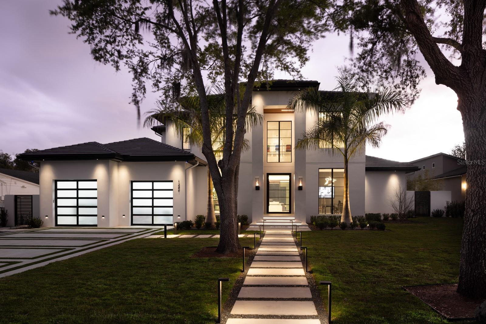 An Award-Winning Architectural Masterpiece built by Chris Salhab with Valdara Custom Homes
Completed 2024
Parade of Homes Showcase Home – Grand Award Winner
Aurora Awards – Custom Home Grand Award
5,164 Sq Ft | 5 Bedrooms | 6 Bathrooms | Deeded Lake Access
Welcome to 1221 Richmond Rd, an extraordinary custom residence located in the coveted Virginia Heights neighborhood of Winter Park—offering deeded lake access to the Winter Park Chain of Lakes. Built by acclaimed Valdara Custom Homes, this architectural showpiece was honored as the 2024 Parade of Homes Showcase Home – Grand Award Winner and recipient of the Aurora Award for Best Custom Home.
Completed in 2024, this 5,164-square-foot estate redefines luxury living with bold design, state-of-the-art technology, and refined craftsmanship. A dramatic 10-foot steel pivot entry door with smart glass sets the tone for what lies within—a seamless blend of art, innovation, and elegance.
At the heart of the home, a sculptural floating staircase makes a powerful architectural statement, while a 30-foot-wide floor-to-ceiling sliding glass wall opens the interiors to an expansive outdoor living space. The lanai, resort-style pool, and custom-designed entertaining areas create the perfect backdrop for gatherings or quiet retreat.
The primary suite is a sanctuary of serenity, complete with a floating center vanity and spa-inspired finishes. Every room has been meticulously curated with high-end materials and modern sophistication, offering an effortless lifestyle that’s both functional and indulgent.
Set on a spacious lot just minutes from Park Avenue, this home offers walkable access to Winter Park’s finest dining, shopping, and culture, while also providing private enjoyment of the lakes and lush surroundings.
Bold. Bespoke. Award-Winning.
Welcome to 1221 Richmond Rd—where architecture, luxury, and lifestyle converge.