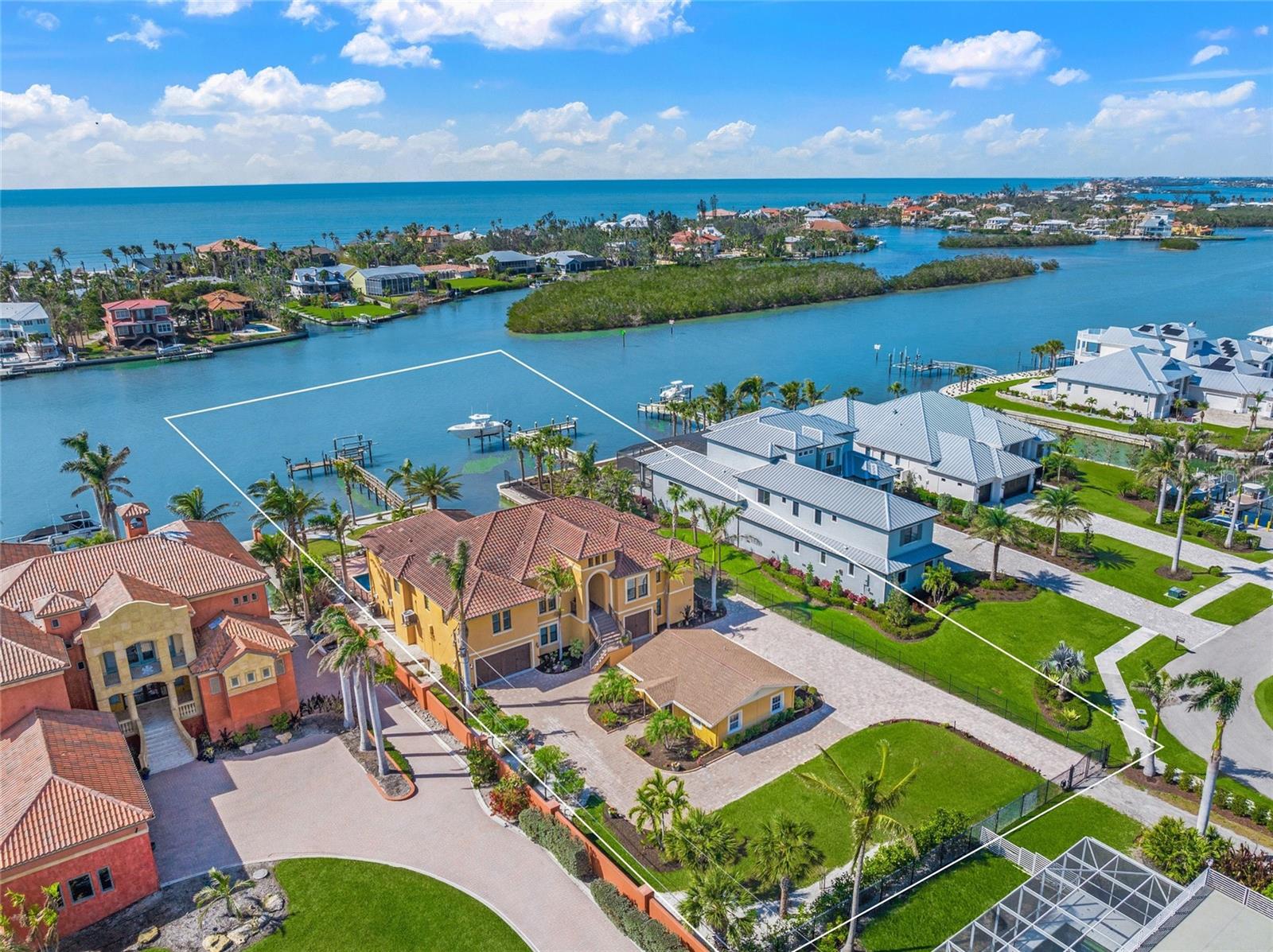 HOMERUN! Hit your own HOMERUN this Summer with $350,000 PRICE IMPROVEMENT! “This is exactly where I Want to be!” That will be the thought as you tour this extraordinary gated estate on the Intracoastal Waterway, with a two-bedroom guest house! Built in 2014, designed by renowned Arthur Rutenberg & boasting over 3500 square feet of living space on one level. The open-concept design is bright & airy, completed by glass walls revealing panoramic views & vibrant sunsets. A few stand-out features are 12-foot coffered ceilings in Great Room, 10-foot ceilings throughout, solid 8-foot doors, security system & elevator. Upgrades include impact-resistant windows & doors, engineered hardwood floors, porcelain tiles, crown molding, plus gourmet kitchen with oversized island, walk-in pantry, Butler’s Pantry with wine cooler, five-burner gas stove, custom wood cabinetry & a built-in 150 bottle Viking wine refrigerator. All air conditioning units were replaced in the last 3 years, with one updated in February 2025. A luxurious, private Master Suite spans 783 square feet along north side of the residence, with tray ceilings, two walk-in closets, impressive master bathroom, & a glass door opening to a covered lanai. Just outside the Master Suite, is a large custom office with built-ins & Plantation shutters. The south side of the residence boasts a spacious, waterfront library with stunning views and fully customized shelving & cabinets. There are two additional bedrooms with plantation shutters, one en-suite, a third bathroom, and the elevator & split-level stairway to the ground floor. The large laundry room is nicely equipped with New Maytag washer & dryer, custom cabinets & plantation shutters. There is a wonderful covered & screened outdoor kitchen fully equipped with an American Outdoor Grill, sink, refrigerator, counter space, & large dining area. Access the rear staircase, from a 2nd lanai to go down to the pool area with an enormous paver deck, bonus room & the dock, with 13,000 lb boat lift and water service. The 3100+ square foot ground floor contains an oversized three-car garage, numerous storage rooms, & convenient bonus room with A/C, full bathroom & sliding glass doors to another covered lanai & heated, saltwater pool. Whether indoors, on a lanai, pool deck, or dock, enjoy front-row seats to nature’s finest entertainment! Hear the Gulf waves roll onto shore, soaring osprey & seagulls, & bi-weekly Drum Circle on Nokomis Beach. Enjoy daily sightings of manatee and dolphin, and boats of all types ranging from runabouts to luxury yachts over 100 feet! The spacious guest house is fully remodeled, updated & furnished, with a open floor plan, well equipped eat-in kitchen, 2 bedrooms, 1 bathroom, 2 vanities & independent laundry. Nestled at the waterfront end of a private lane, shared only by two other homes, on a 26,000+ square foot lot, four blocks north of Albee Bridge & across from Casey Key & Nokomis Beach. Embrace the beach lifestyle, where you can easily golf cart, bike, or walk to waterfront dining, tiki bars with live music. Golf carts are a favorite mode of transportation in Nokomis Beach, so a car is not necessary to shop or do everyday errands! Golf Cart to Publix, pharmacy, Post Office, nail salon, dog groomer, haircut, boutique shopping & much more. Evening sunsets ignite the sky into rotating vibrant colors, & in that moment, you’ll know, “Nokomis is not Just a place, but a State-of-Mind & this is Right where I Need to be!”
