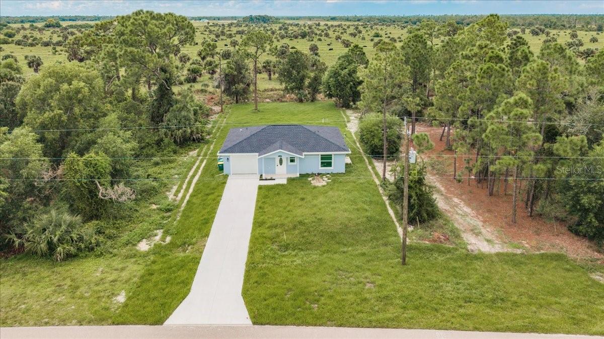 Skip the stress of building and move right into this brand-new 2-bedroom, 1-and-a-half-bathroom home with an attached garage, nestled in the peaceful rural community of Tropical Gulf Acres. Featuring an open-concept layout with a spacious great room, this home offers versatile living and entertaining space. Interior highlights include elegant wood-look luxury vinyl flooring throughout, tray ceilings in both the great room and primary bedroom, stylish light and ceiling fan fixtures, and recessed lighting for a modern touch. The kitchen is a standout with granite countertops, an abundance of shaker style cabinets, stainless steel appliances, a pantry, built-in buffet, and a breakfast bar that flows seamlessly into the great room—perfect for entertaining guests. The primary suite includes a built-in closet and a private full bath with a granite-topped vanity and linen storage. The guest bedroom also features a built-in closet. Additionally, a half bath in the hall adds to the practicality of the home. The property is further complemented by a single-car garage with ample space and a designated laundry area, providing the perfect combination of functionality and convenience. Hurricane impact windows throughout, provide enhanced storm protection, energy efficiency, and peace of mind year-round. Whether you're enjoying a quiet evening on the patio or entertaining friends in the open and inviting living space, this home is a haven of comfort and style. With its modern amenities, quality finishes, and the charm of being a single-owner property, this residence is ready to welcome its next chapter of memories. Located in a quiet, family-oriented neighborhood with no HOA or CDD. Minutes from historic downtown Punta Gorda, Fisherman's Village Restaurants, shopping, waterfront parks, events, and more. Close to I-75 and US-41. Near two airports: Punta Gorda and Southwest Florida International. Tropical Gulf Acres has a country-like feel, yet in a reasonable commute to Port Charlotte, Fort Myers, or Cape Coral. **PLEASE ENJOY THE 3D INTERACTIVE VIRTUAL TOUR ASSOCIATED WITH THIS LISTING**